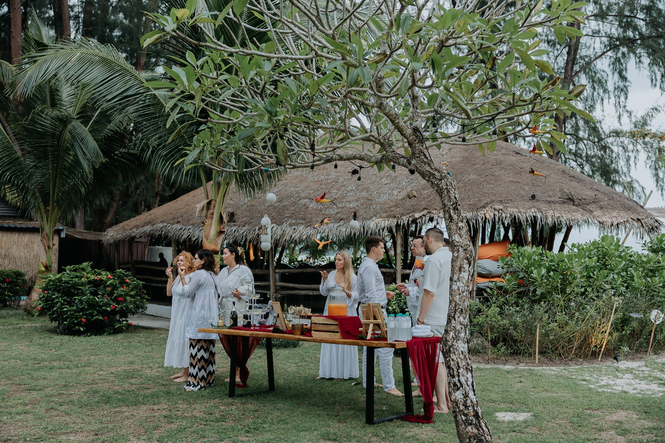 Bride and groom participating in a sacred Buddhist wedding blessing in Thailand