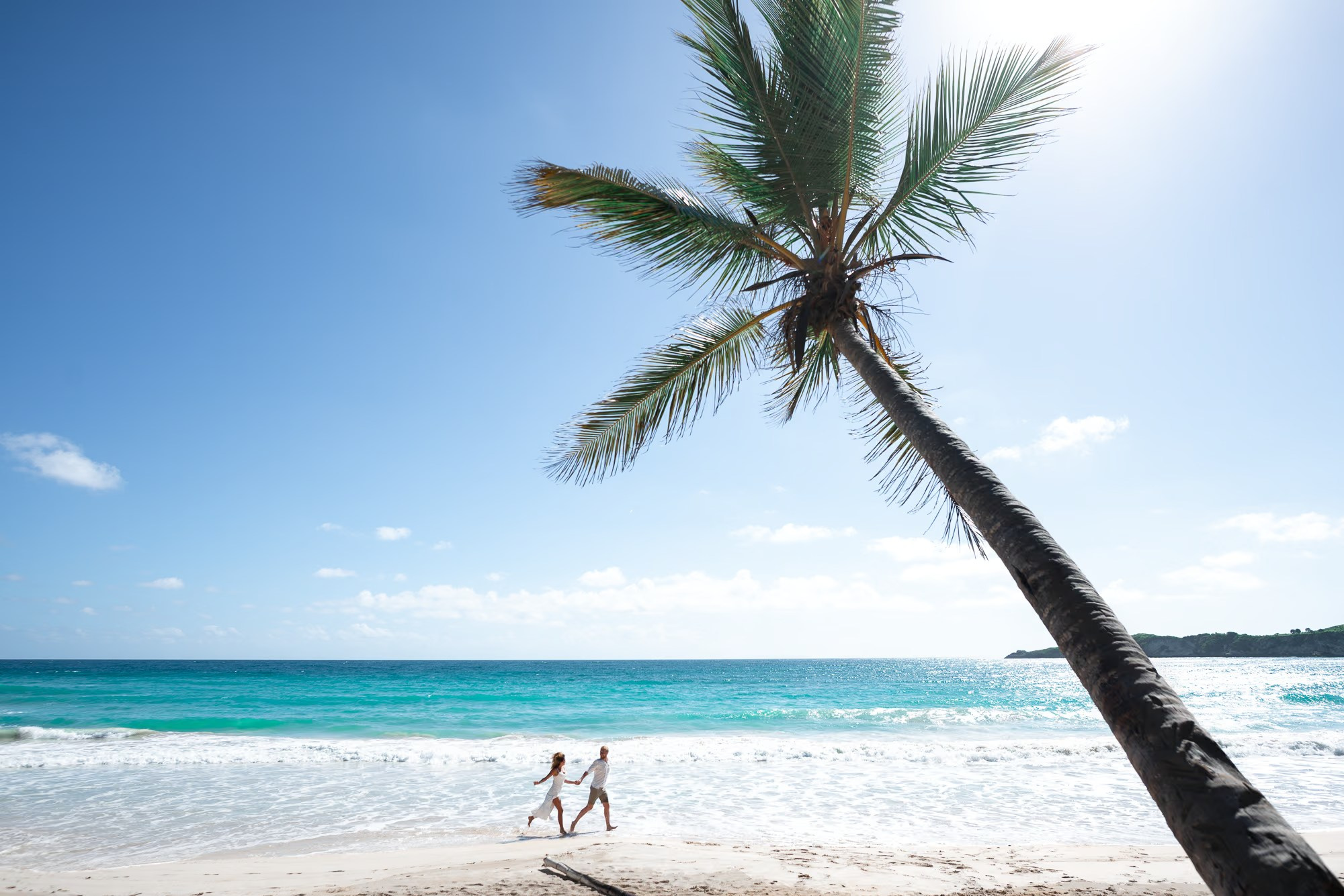 Beach photo session Punta Cana featuring a happy couple enjoying their vacation.