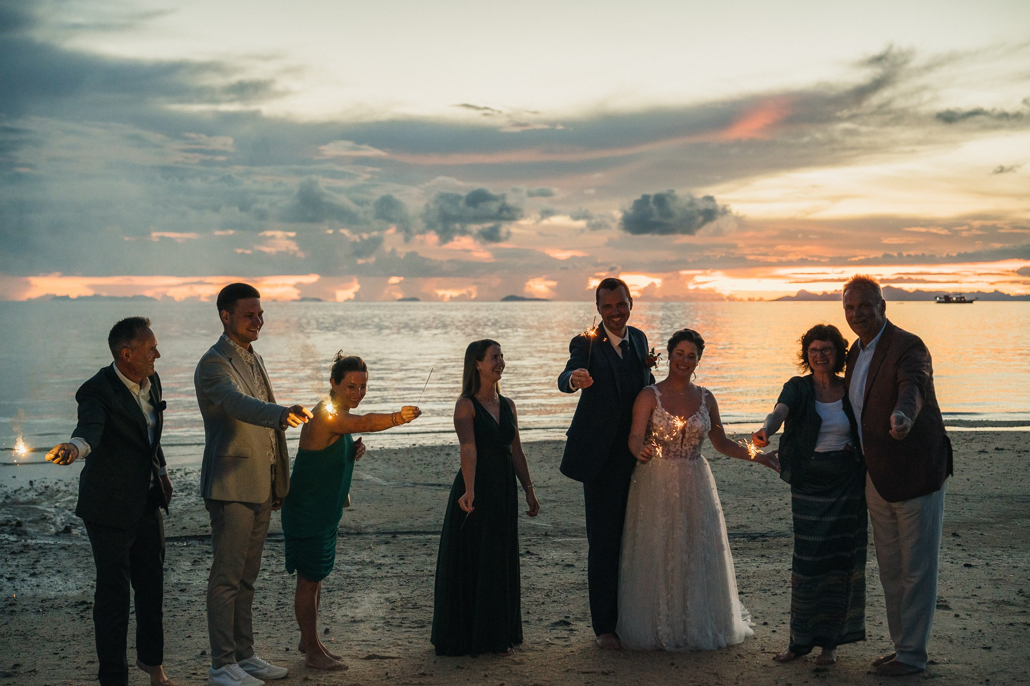 Destination beach wedding in Koh Samui, Thailand with the couple, family members and friends enjoying a tropical wedding ceremony by the sea