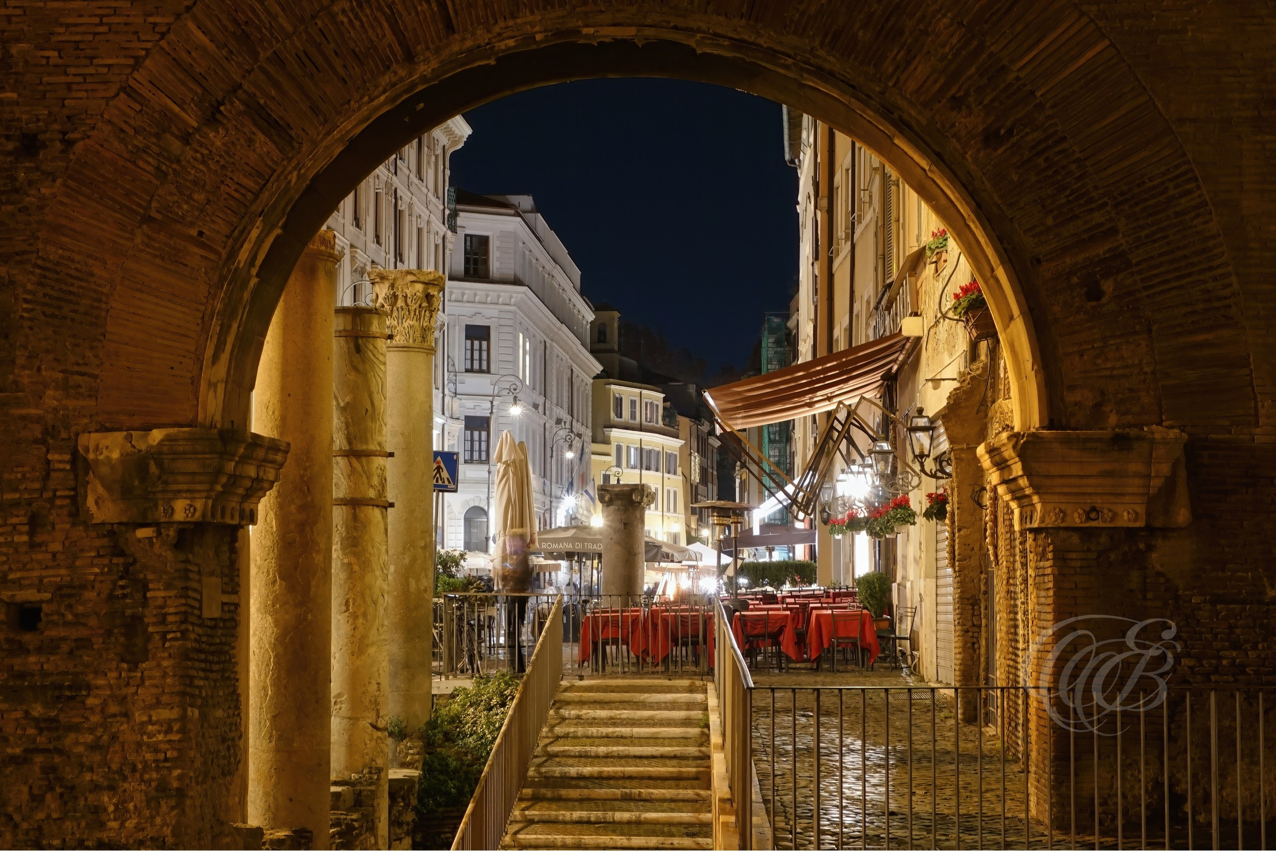 ITALY TRAVEL PHOTOGRAPHY – ITALY – ROME — Porticus Octavia Archway — Ancient Roman archway remains of the Porticus of Octavia near the Theatre of Marcellus, showing imperial-era architectural ruins in Rome, Italy — Eduardo Bartoli Photography.