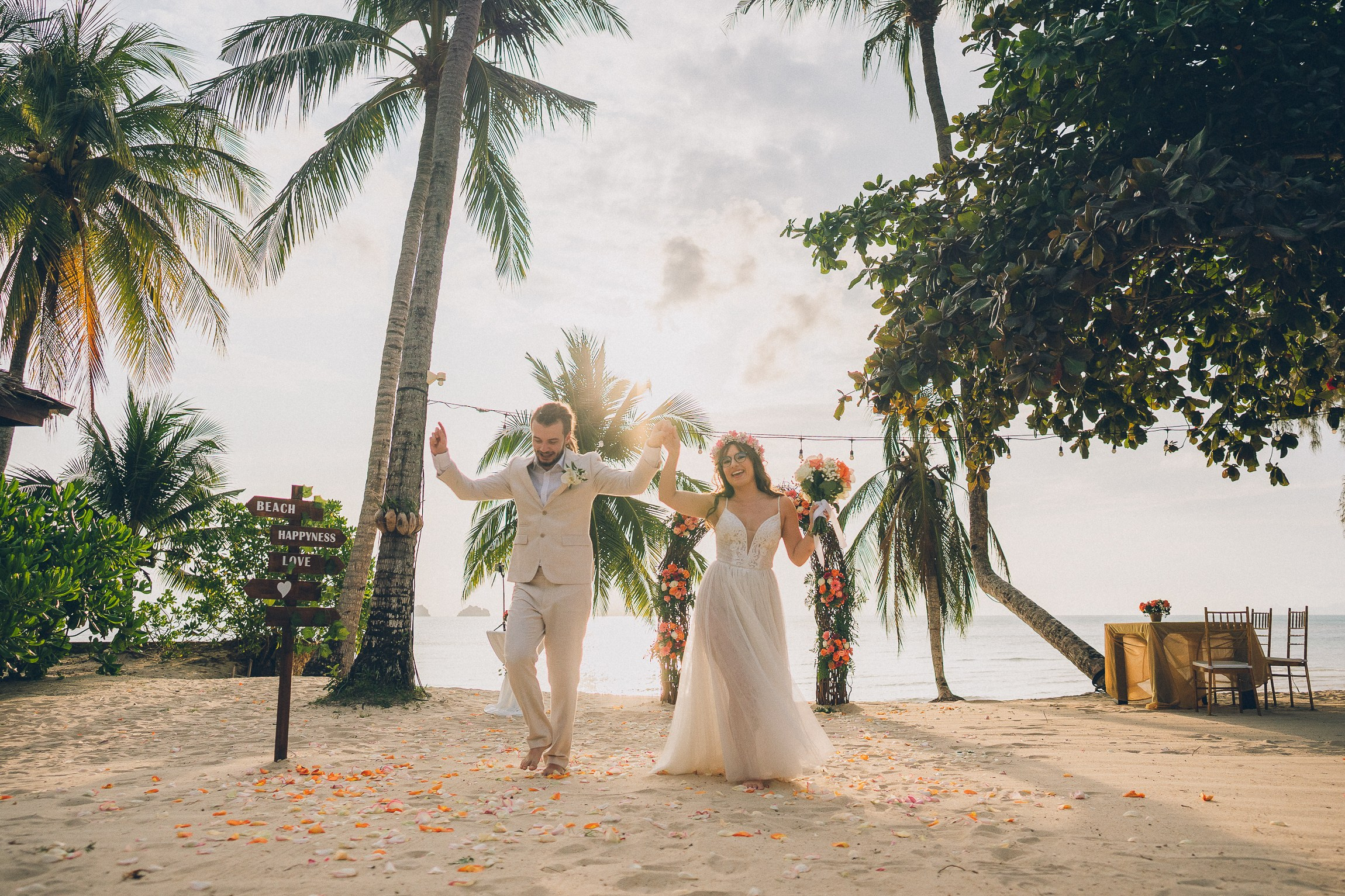 Bride and groom enjoying a just for 2 beach wedding in Koh Samui, Thailand, surrounded by tropical scenery and ocean views
