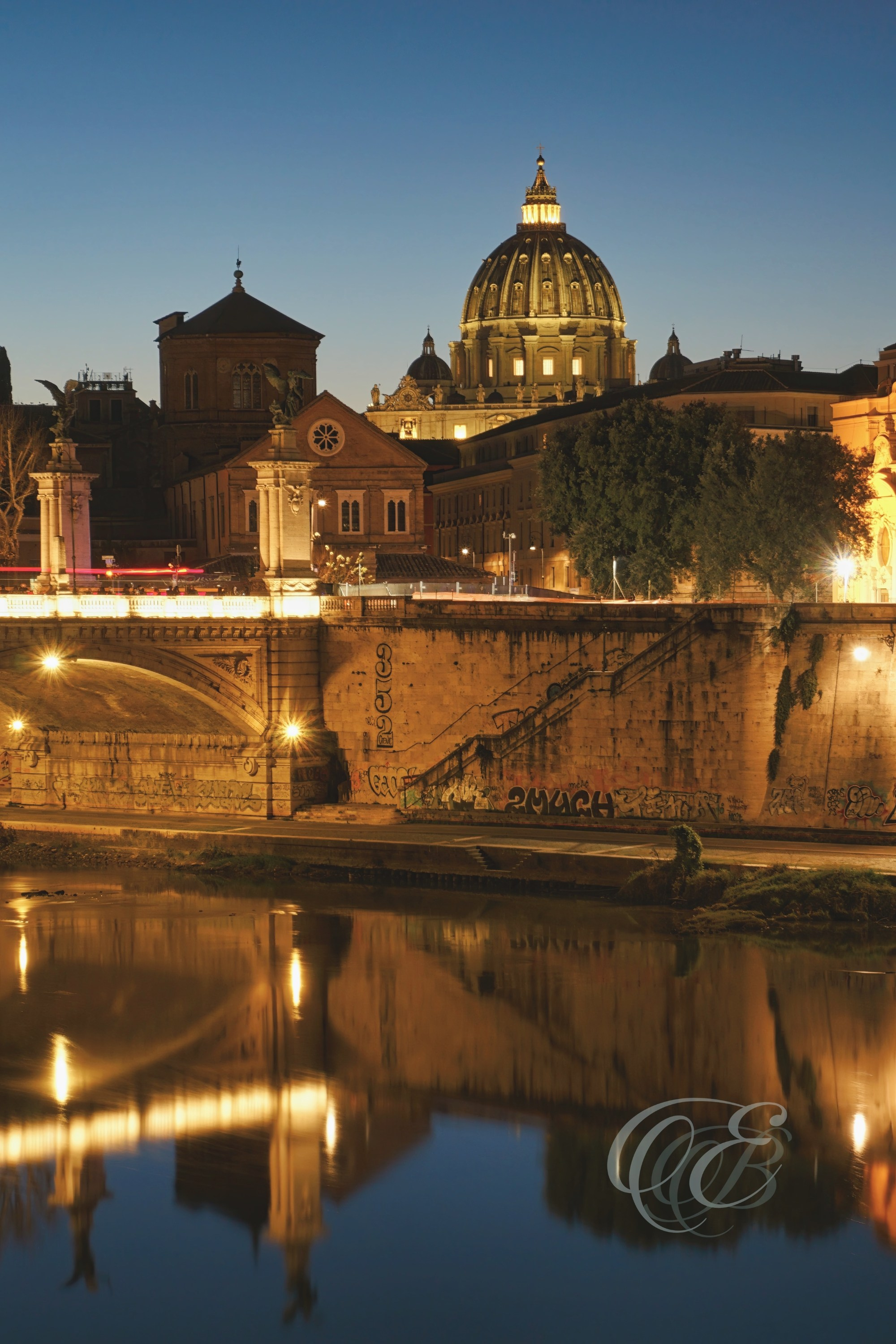 Rome, Italy – Blue hour view of Ponte Vittorio Emanuele II over the Tiber River with evening light reflections and historic bridge structure – Eduardo Bartoli Photography.