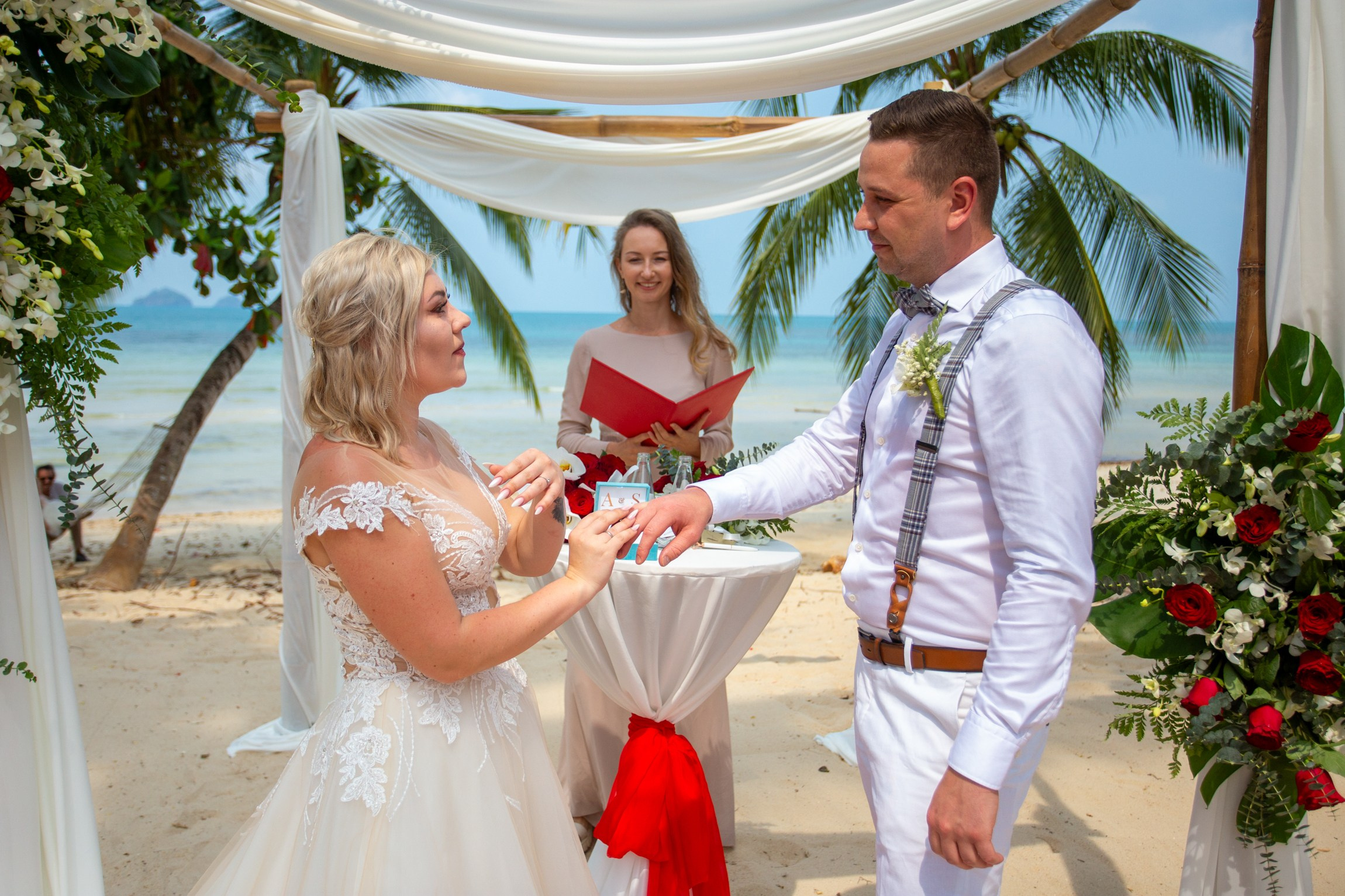 Elegant beach wedding setup on Koh Samui, Thailand with bride, groom, flowers and stunning sea backdrop