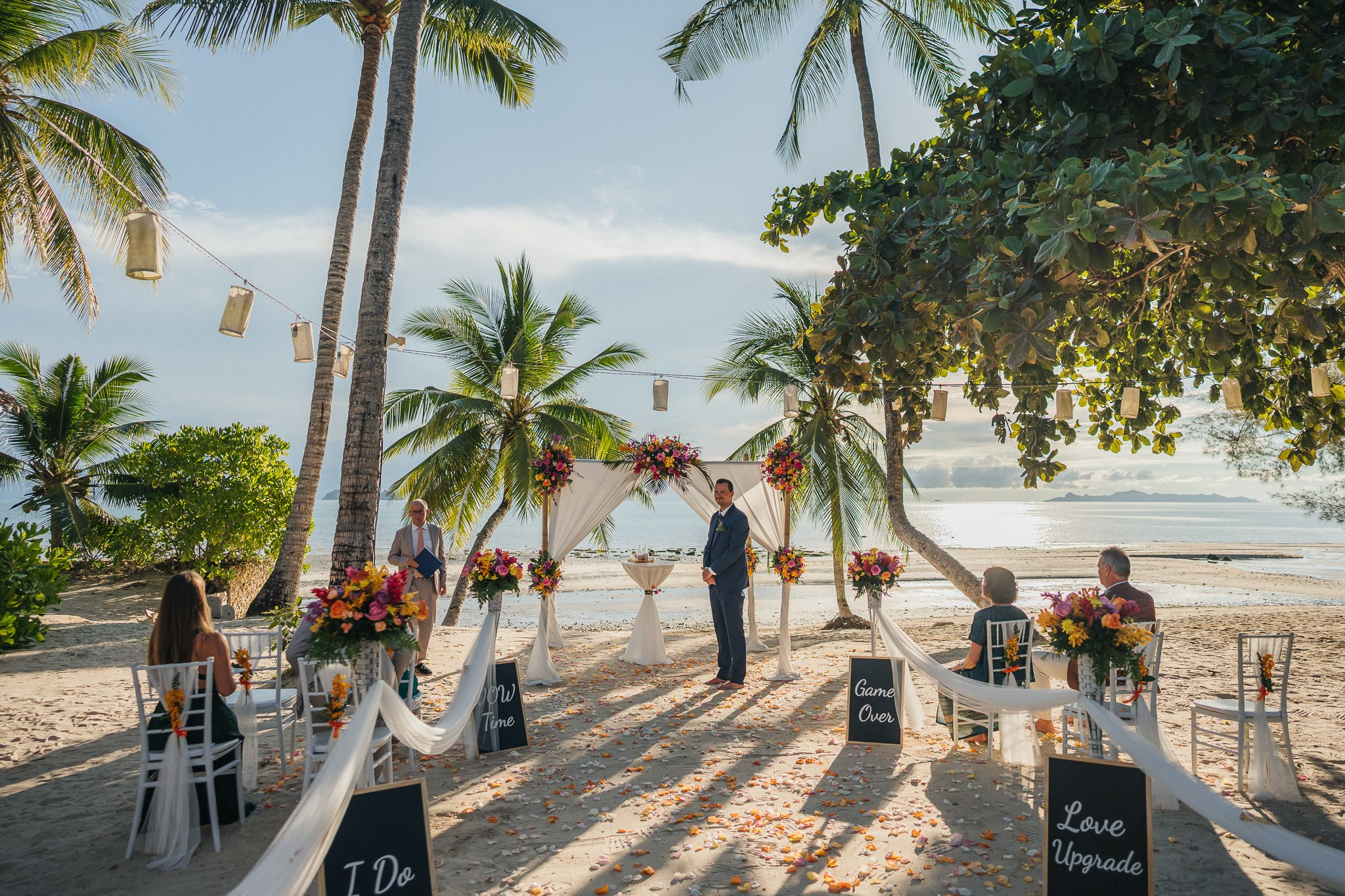 Destination beach wedding in Koh Samui, Thailand with the couple, family members and friends enjoying a tropical wedding ceremony by the sea