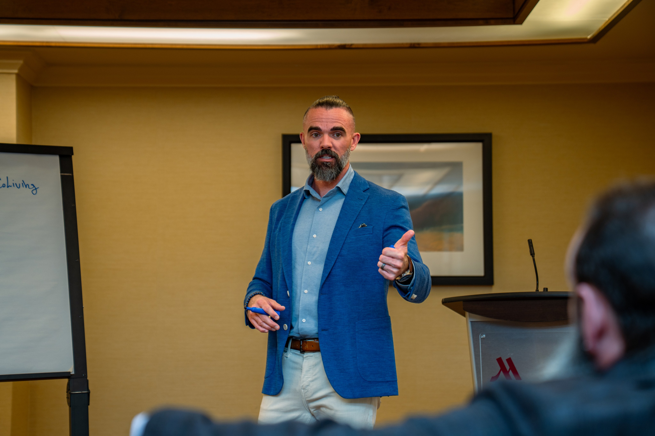 Matt Poechman presenting to attendees at real estate networking event