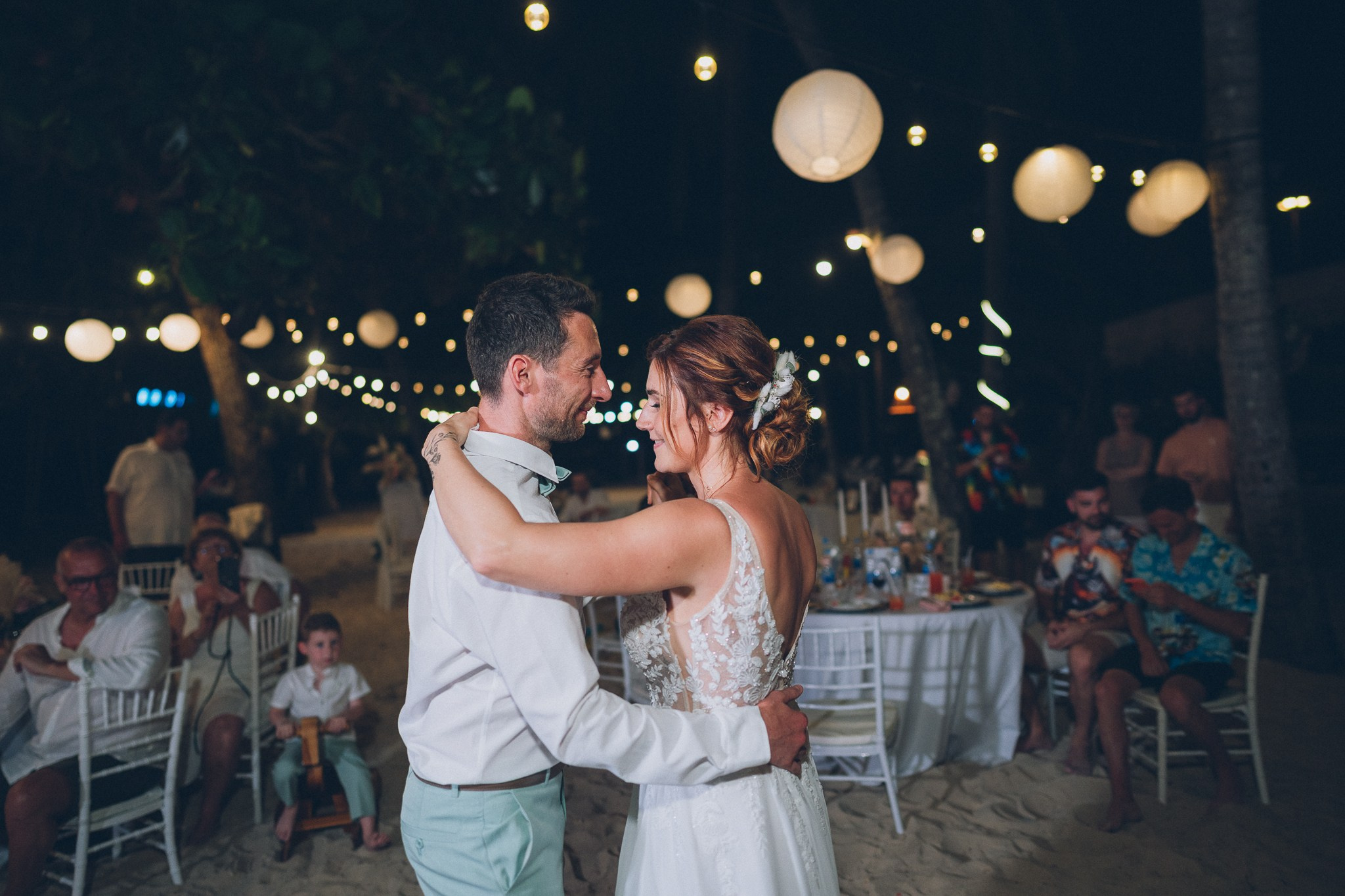 Wedding celebration with guests on a tropical sunset beach in Koh Samui