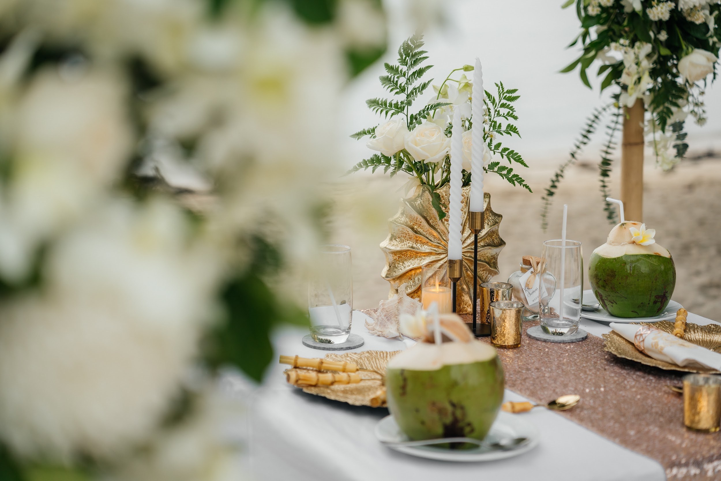 Elegant beach wedding setup on Koh Samui, Thailand with bride, groom, flowers and stunning sea backdrop