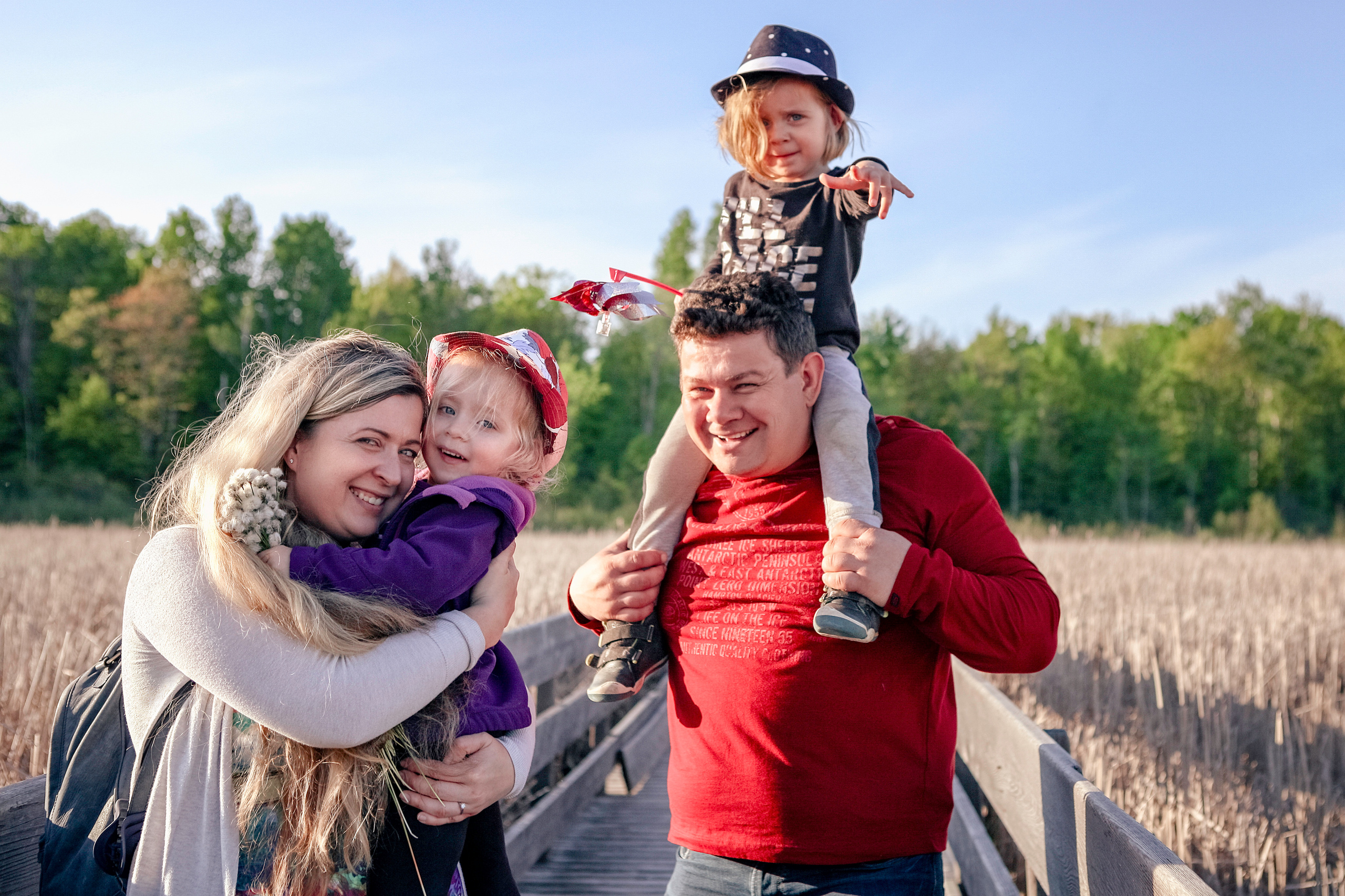 Candid family lifestyle photography in an open field, Kingston ON photographer.