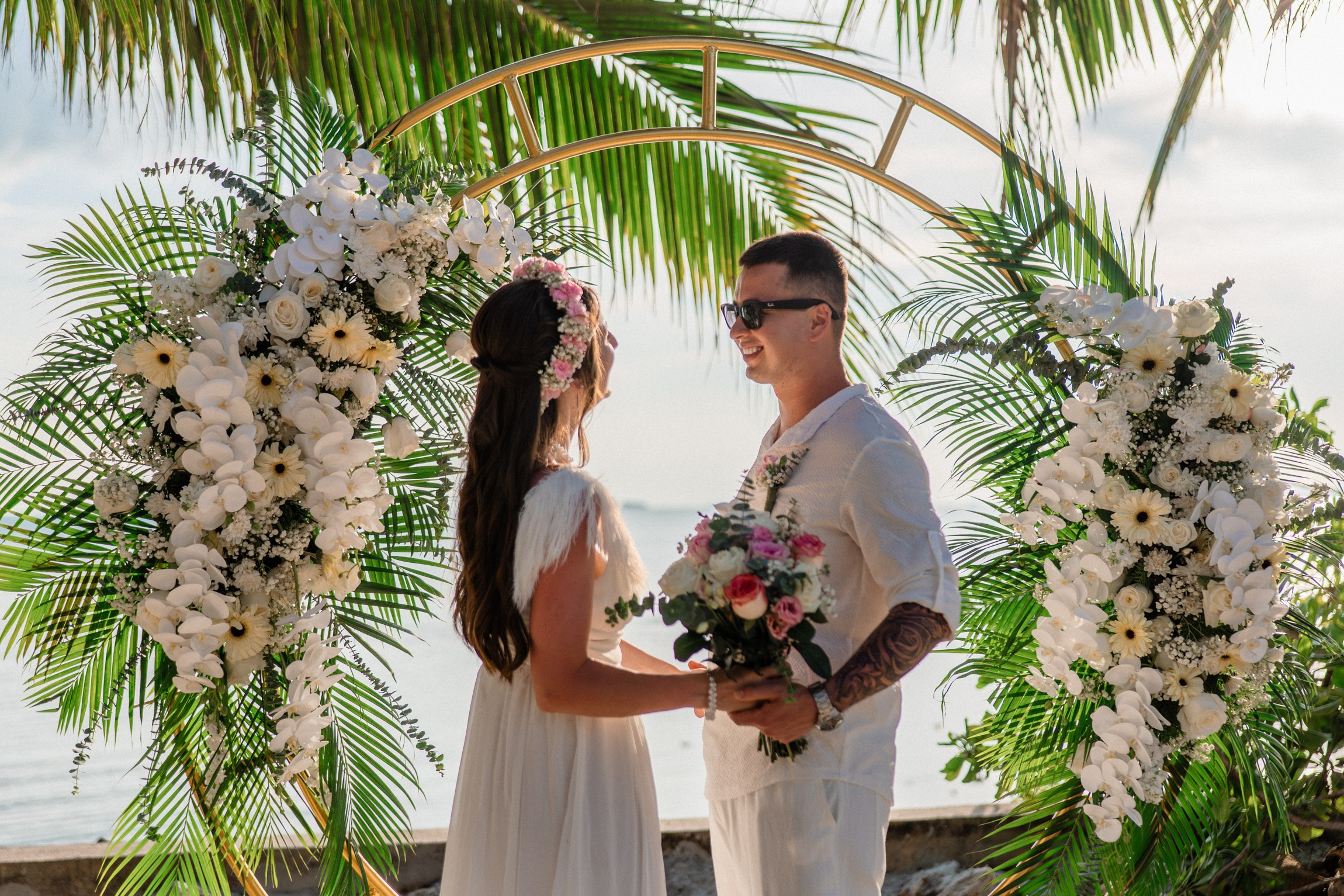 Bride and groom exchanging vows on a private sunset beach
