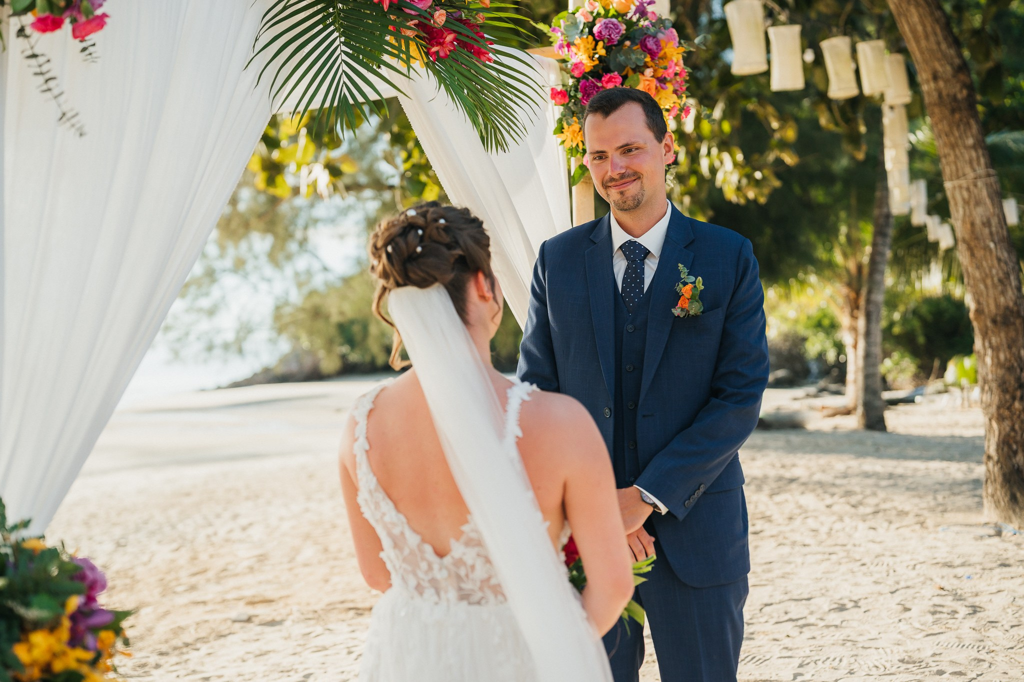 Destination beach wedding in Koh Samui, Thailand with the couple, family members and friends enjoying a tropical wedding ceremony by the sea