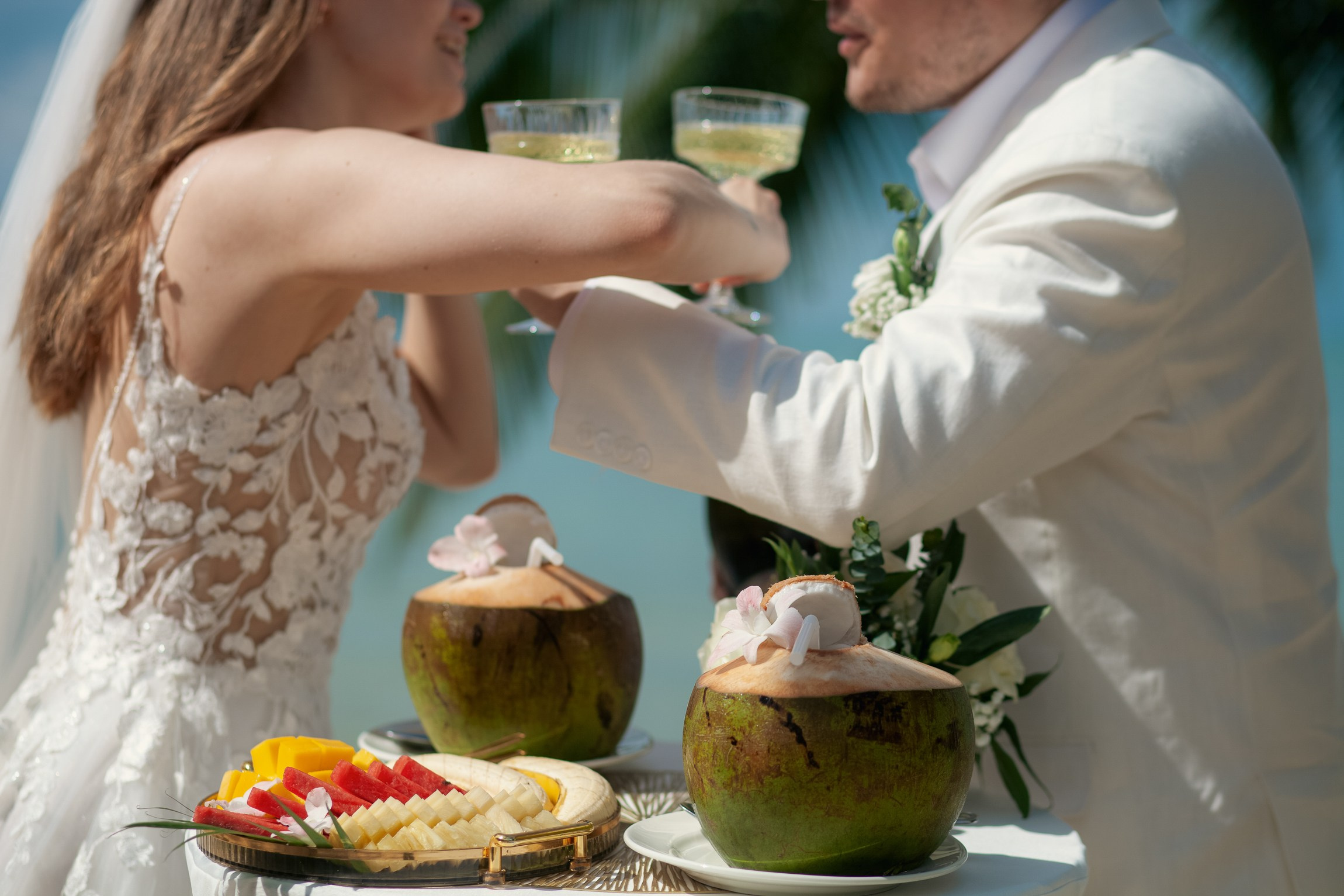 Bride and groom celebrating a beach wedding with their children in Koh Samui, Thailand, surrounded by tropical scenery and ocean views