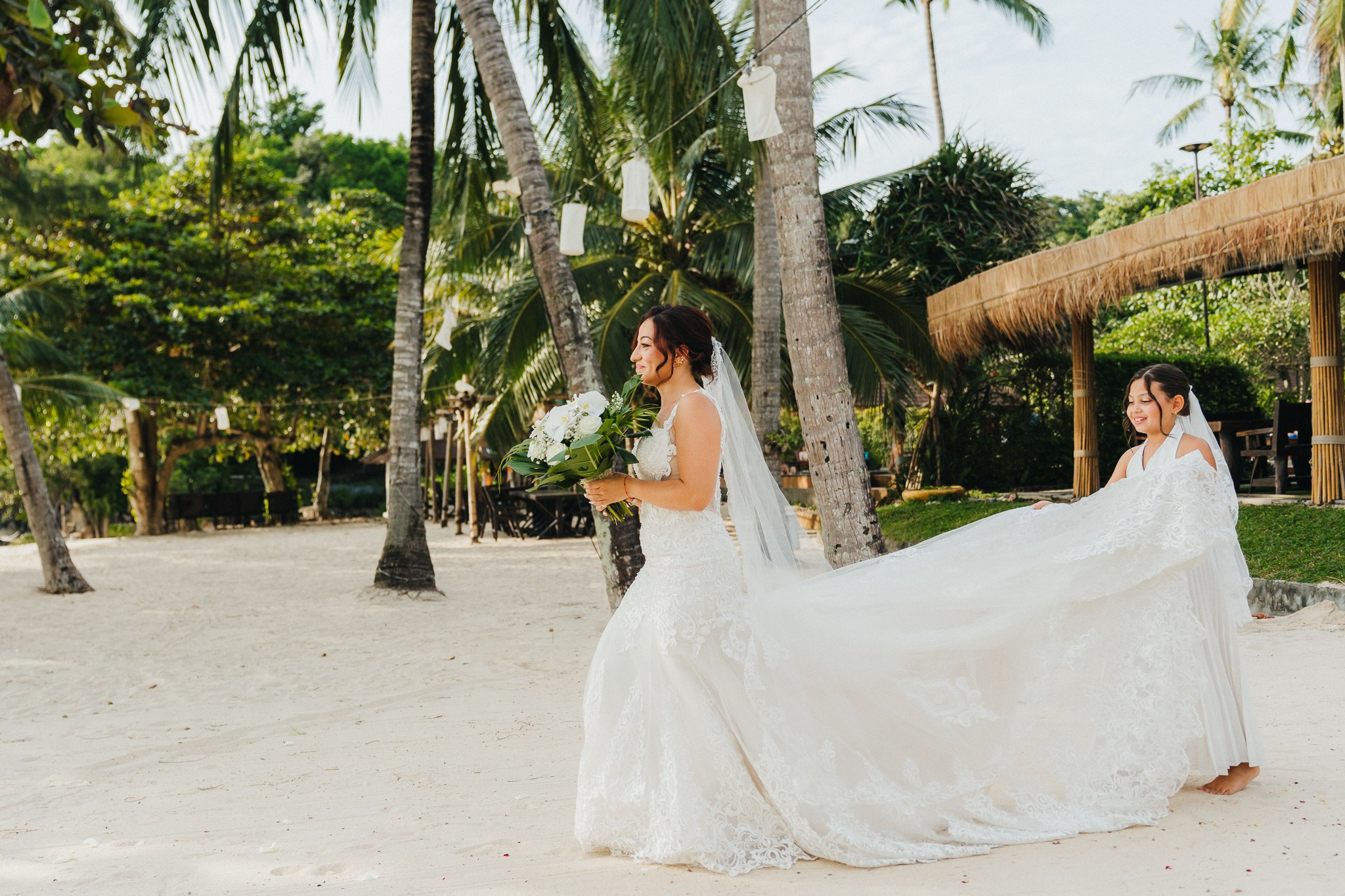Intimate family wedding on the beach in Koh Samui, Thailand with the couple and their children enjoying the ceremony together