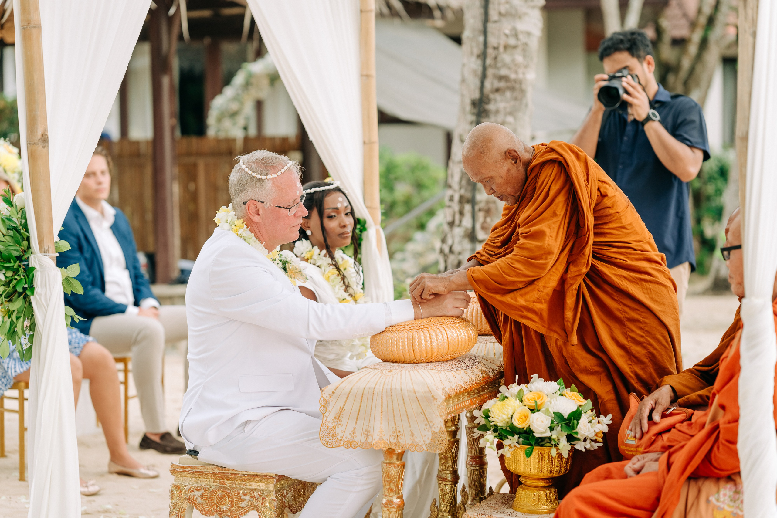Couple celebrating a spiritual Buddhist wedding ceremony on Koh Samui