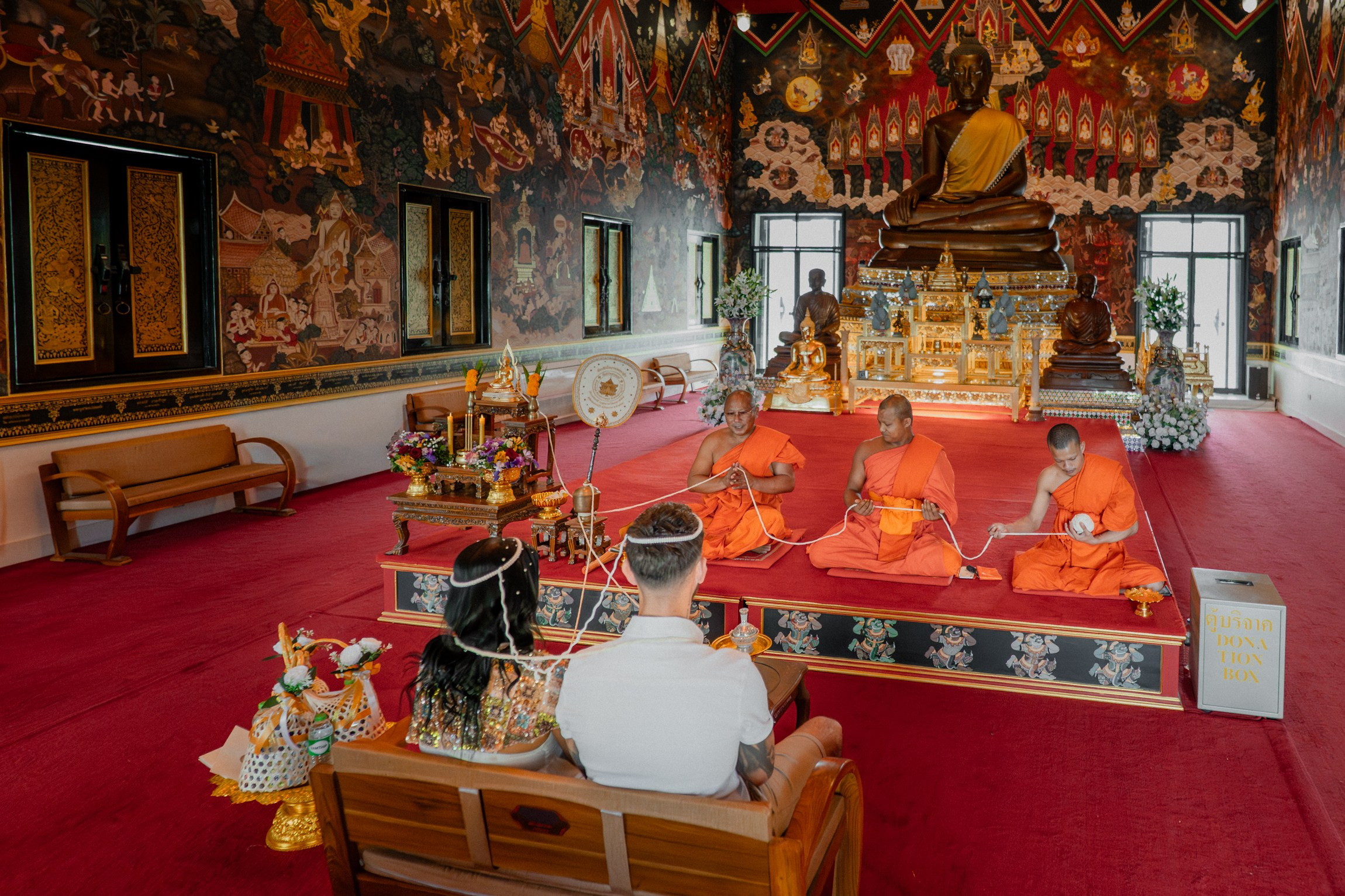 Buddhist wedding ceremony in Koh Samui with monks and traditional Thai rituals in Temple