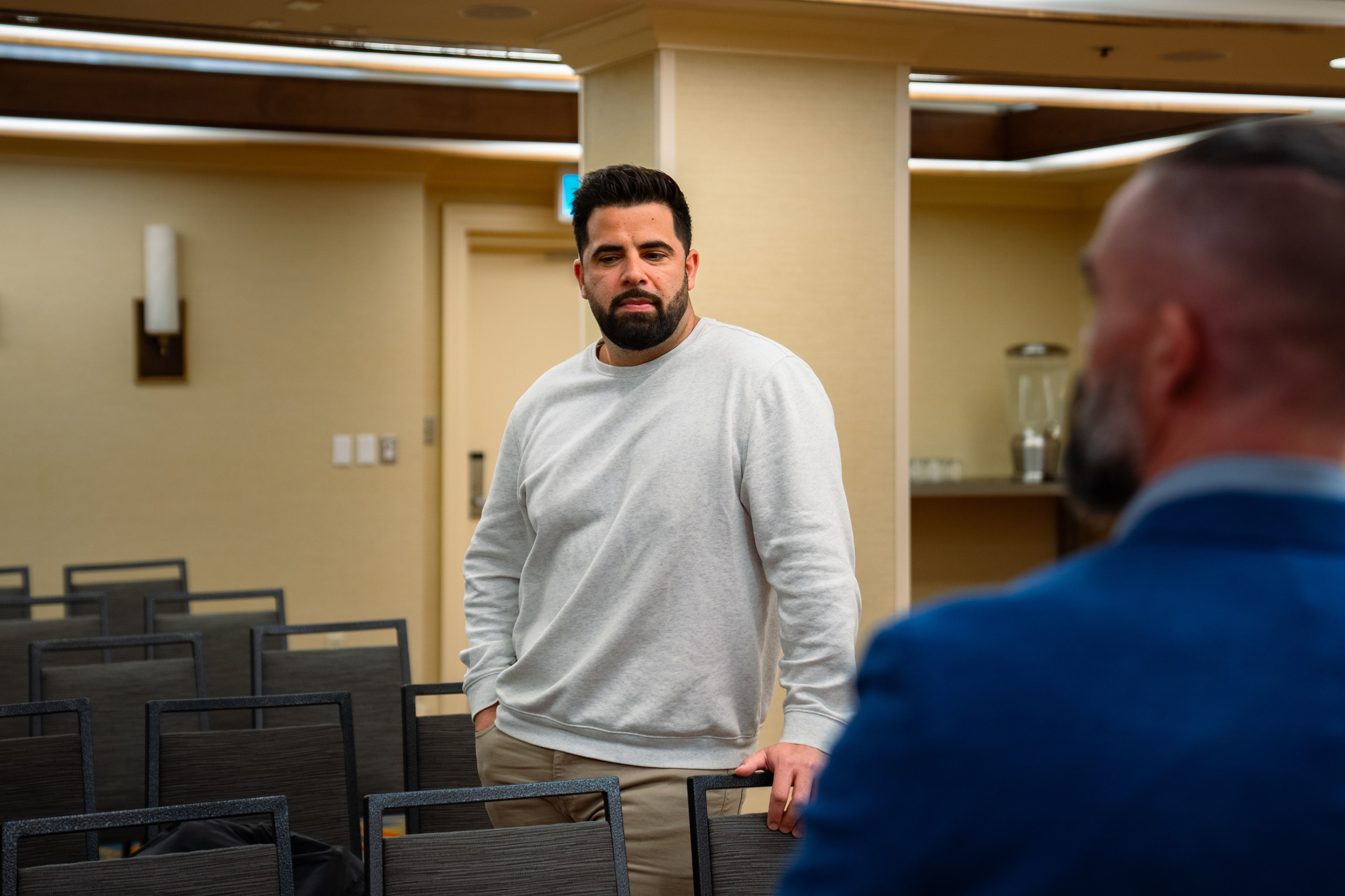 Attendees standing in conversation at real estate event
