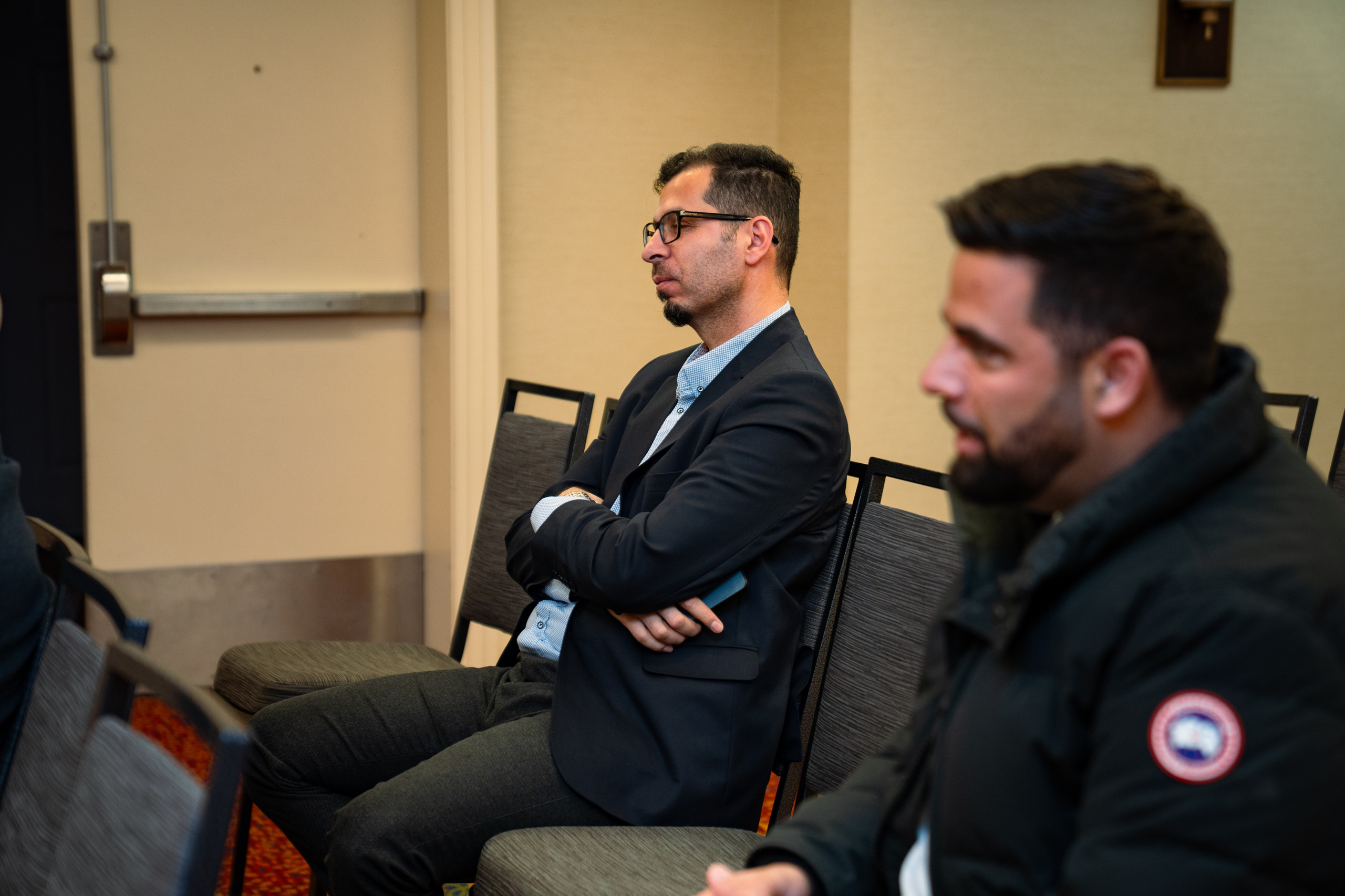 Attendees seated in discussion at real estate networking event
