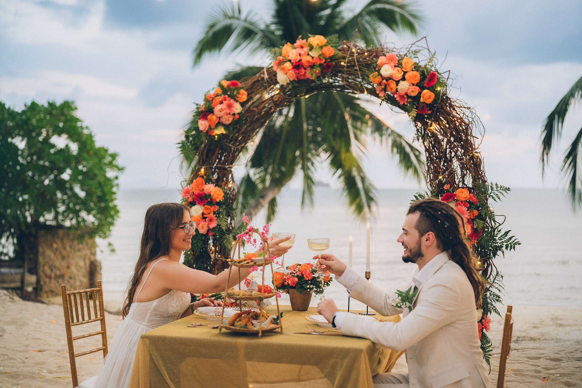 Intimate wedding for two on a tropical beach in Koh Samui, Thailand with a floral wedding setup and sea view