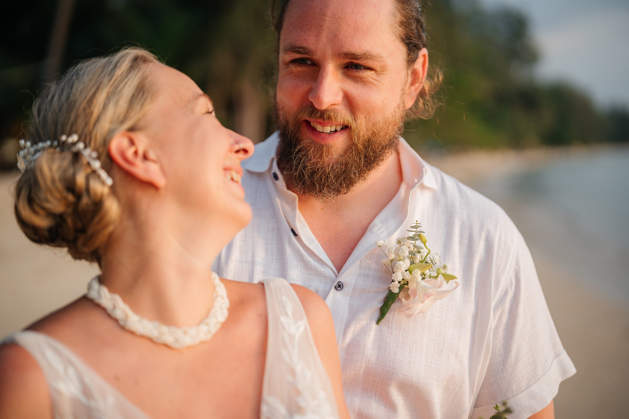 Destination beach wedding in Koh Samui, Thailand with the couple, family members and friends enjoying a tropical wedding ceremony by the sea