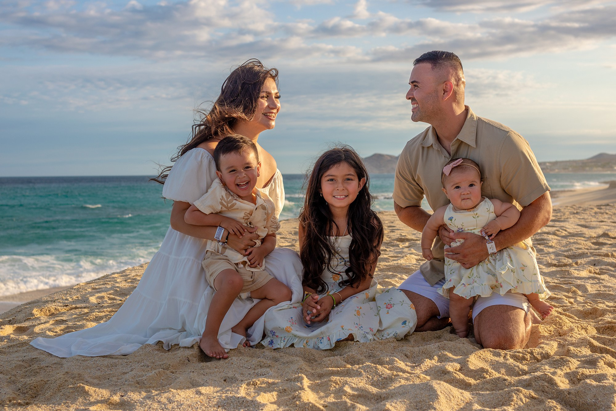 Sunset family portrait in Los Cabos – parents and children at Villa La Valencia beach, warm light and emotional destination family photography