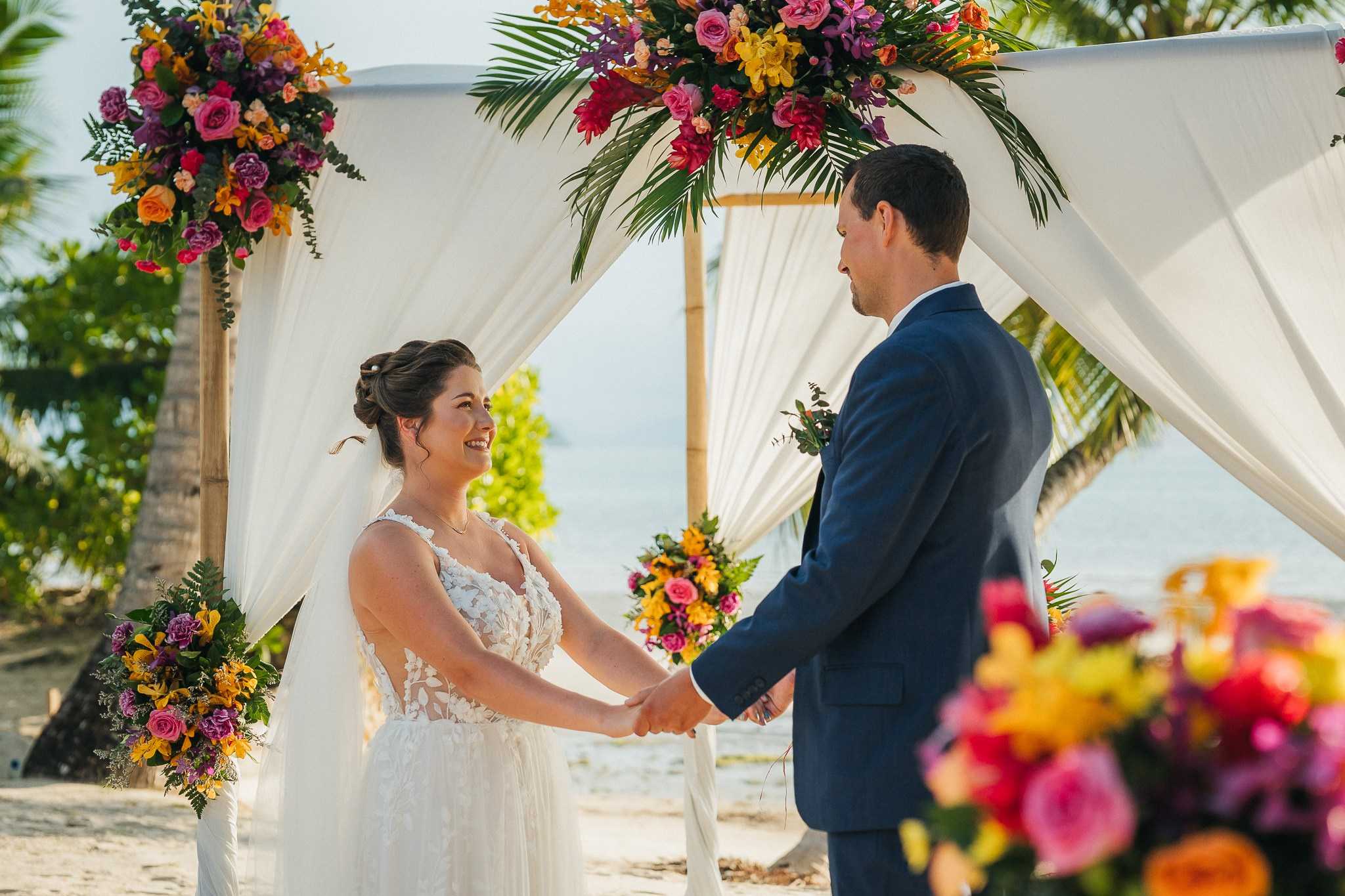 Destination beach wedding in Koh Samui, Thailand with the couple, family members and friends enjoying a tropical wedding ceremony by the sea