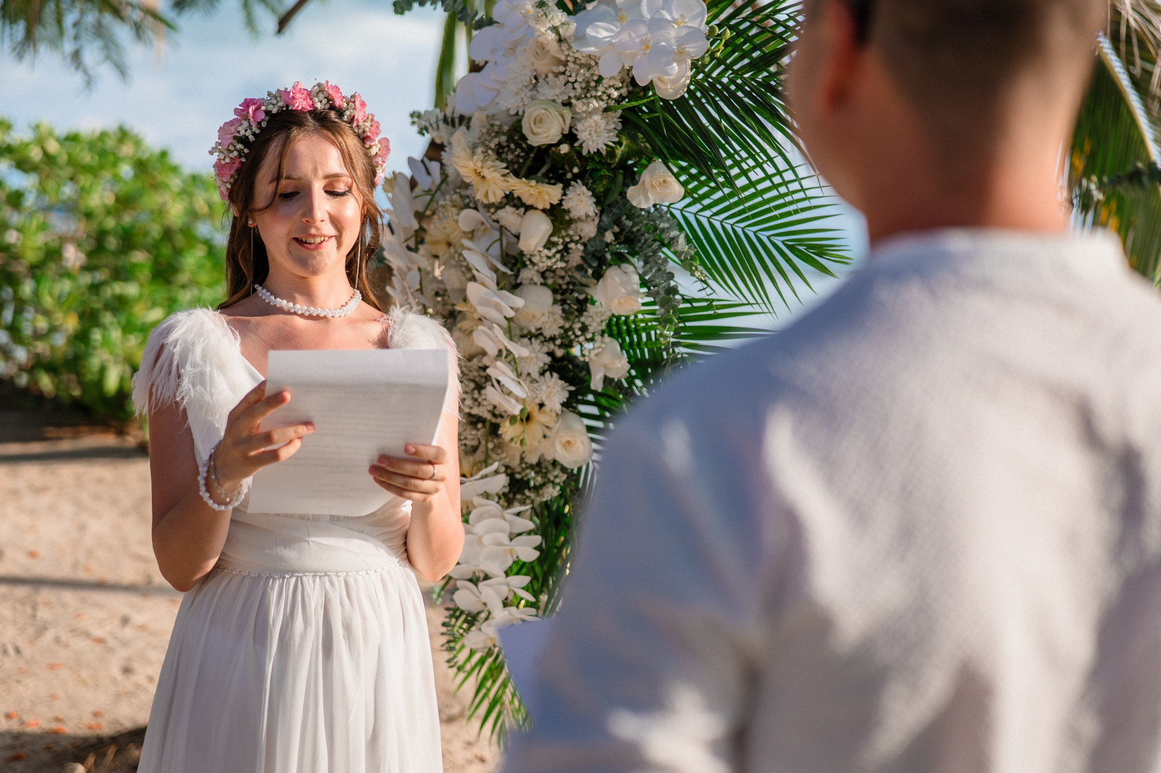 Bride and groom exchanging vows on a private sunset beach