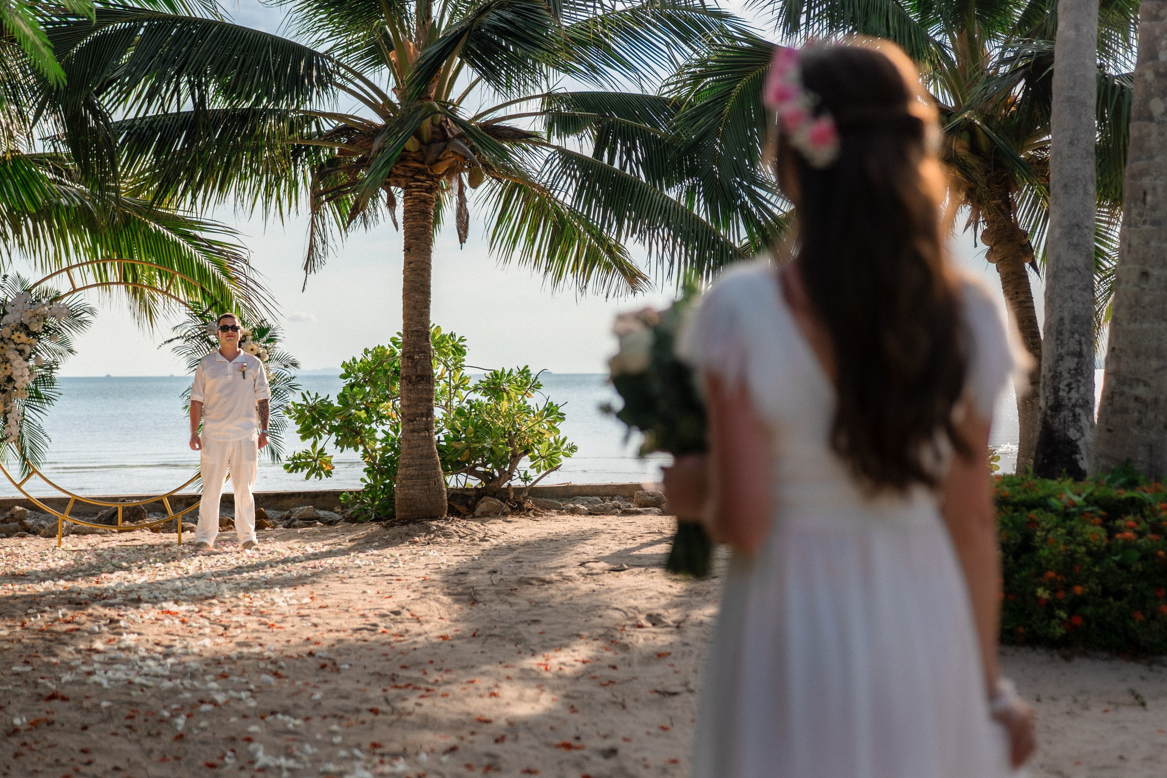Bride and groom exchanging vows on a private sunset beach