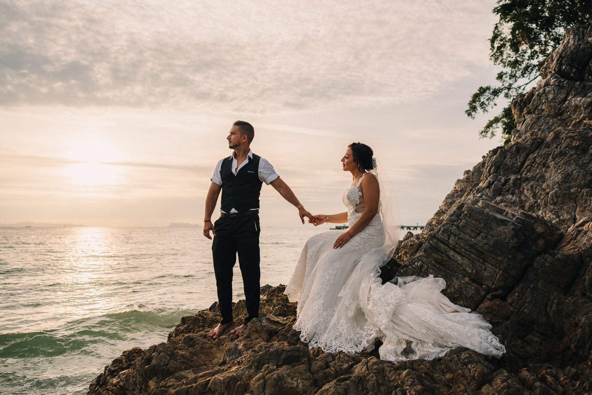 Bride and groom celebrating a beach wedding with their children in Koh Samui, Thailand, surrounded by tropical scenery and ocean views