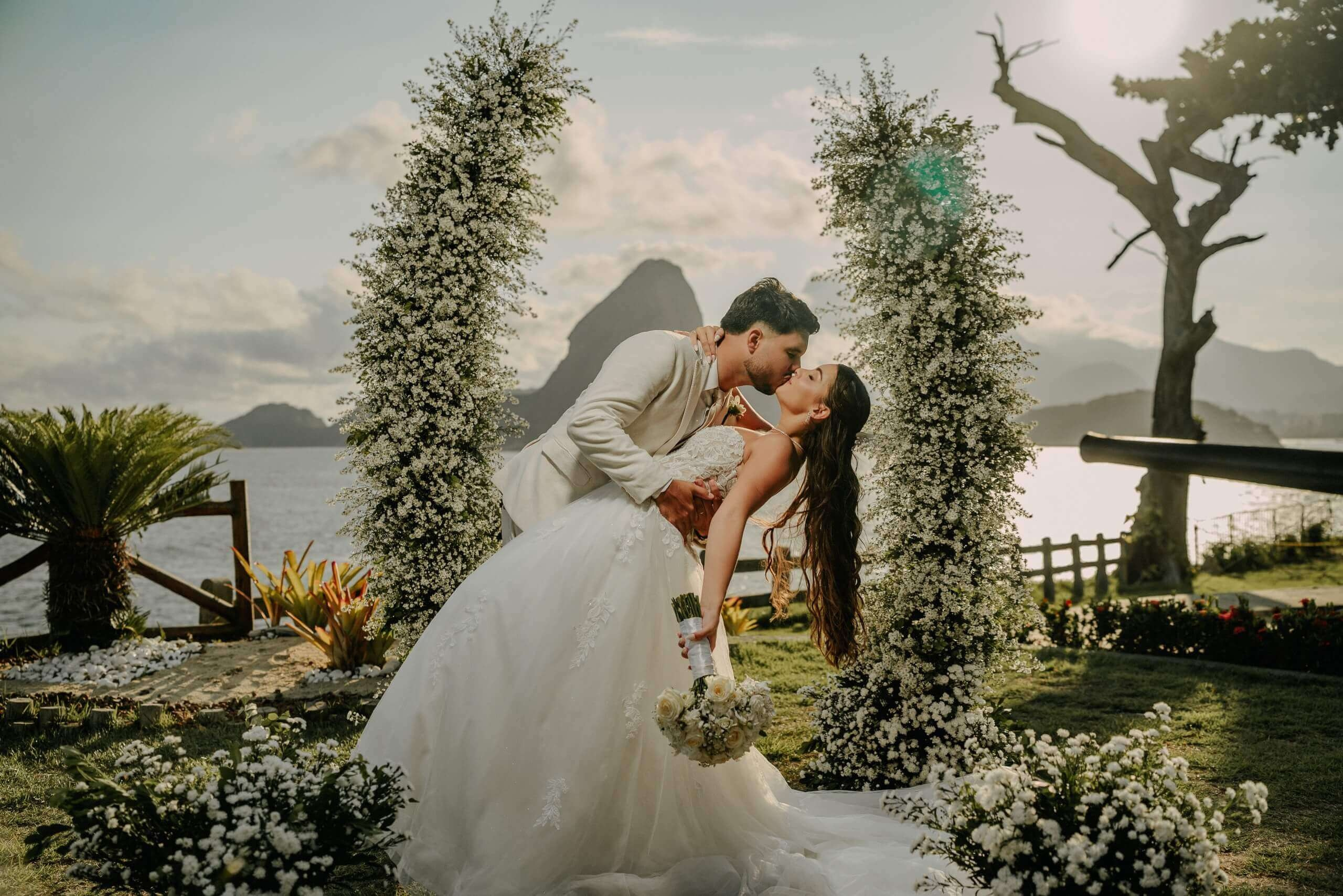 Outdoor wedding ceremony couple with breathtaking Sugarloaf Mountain view in Rio de Janeiro, perfect romantic destination wedding in Brazil.