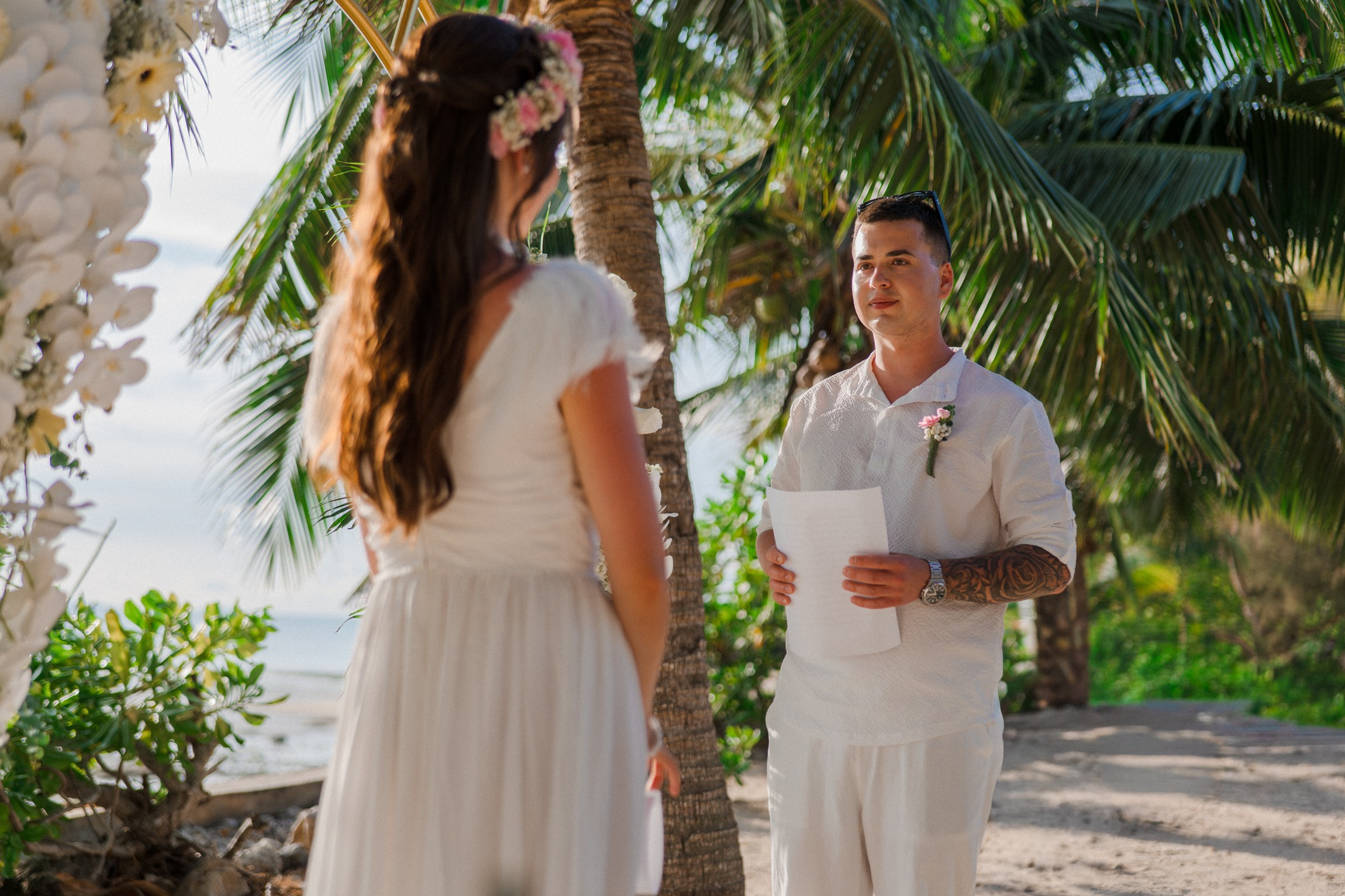 Bride and groom during a romantic beach wedding ceremony on Koh Samui, Thailand, surrounded by tropical scenery and ocean views