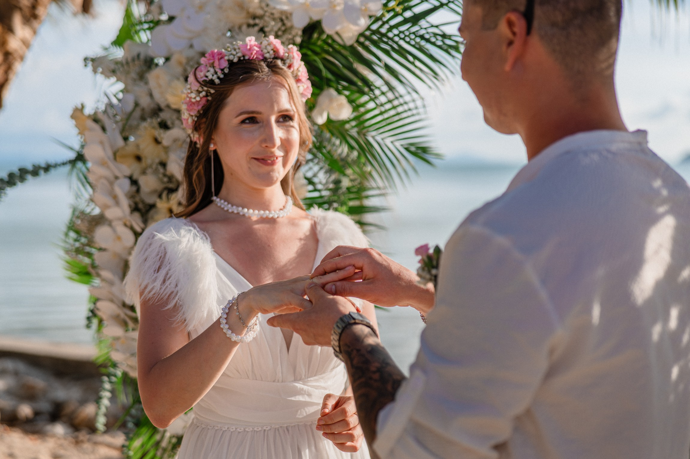 Bride and groom exchanging vows on a private sunset beach