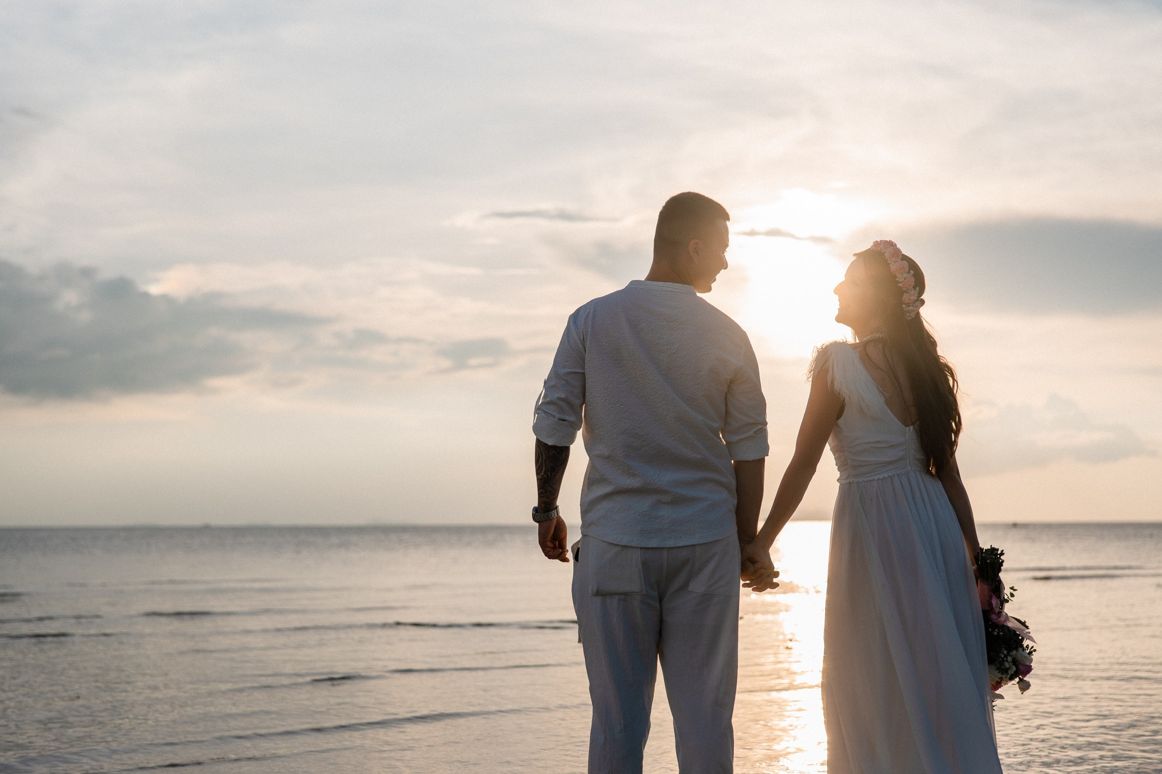 Bride and groom during a romantic beach wedding ceremony on Koh Samui, Thailand, surrounded by tropical scenery and ocean views