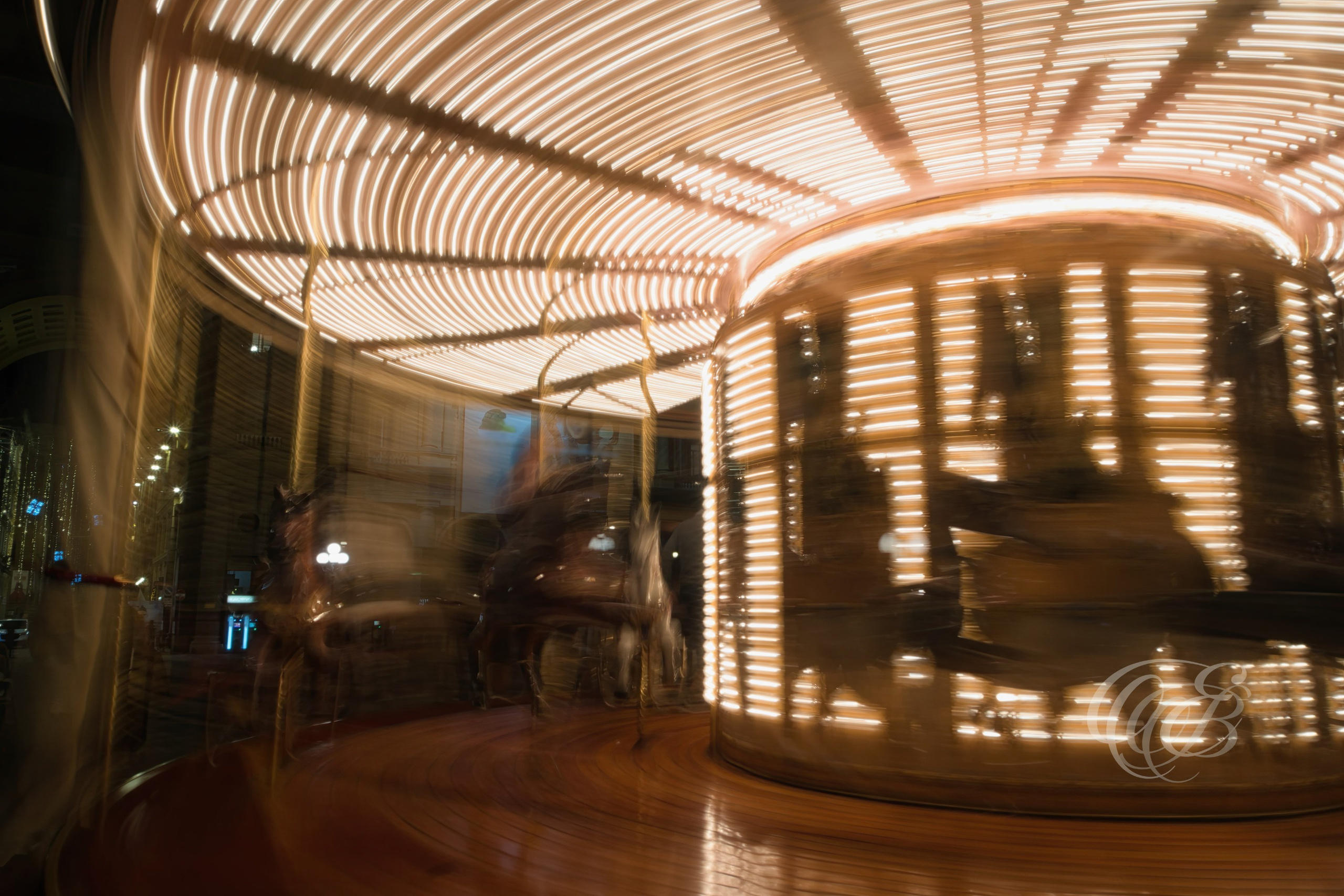 Florence, Italy—Lights of a Moving Carousel—Eduardo Bartoli Photography—Long-exposure photograph of a moving carousel in Florence, Italy, where lights and motion create abstract patterns and flowing forms within the historic city center—Florence, Italy—Lights of a Moving Carousel—Eduardo Bartoli Photography.