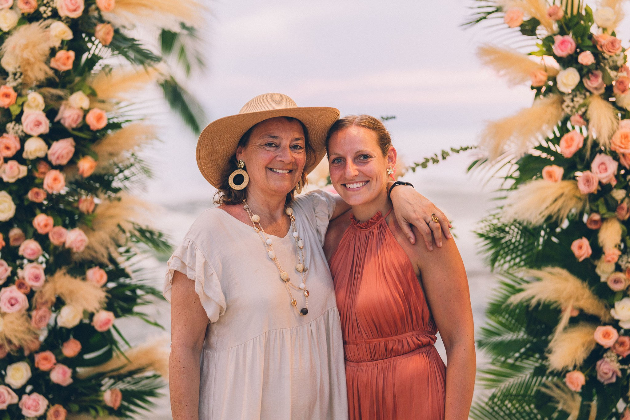 Wedding celebration with guests on a tropical sunset beach in Koh Samui