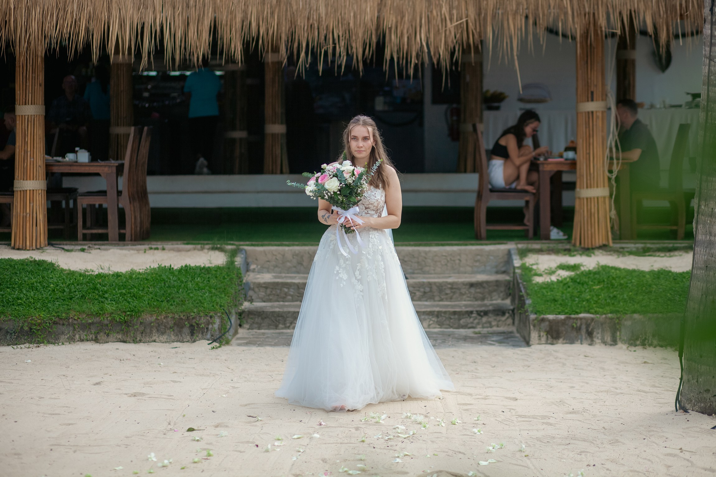 Romantic destination wedding on Koh Samui beach with tropical flowers, ocean views and happy newlyweds