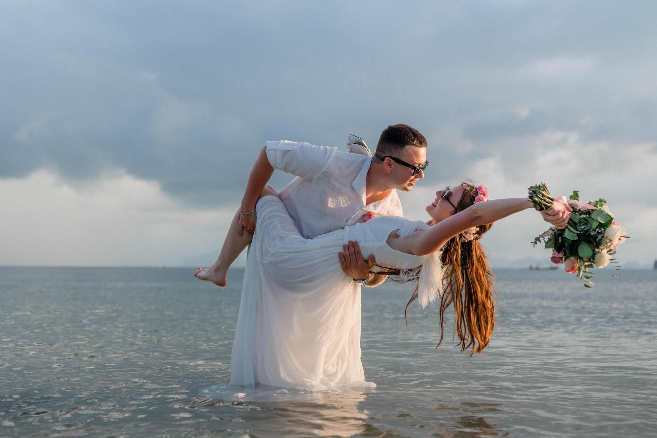 Bride and groom exchanging vows on a private sunset beach