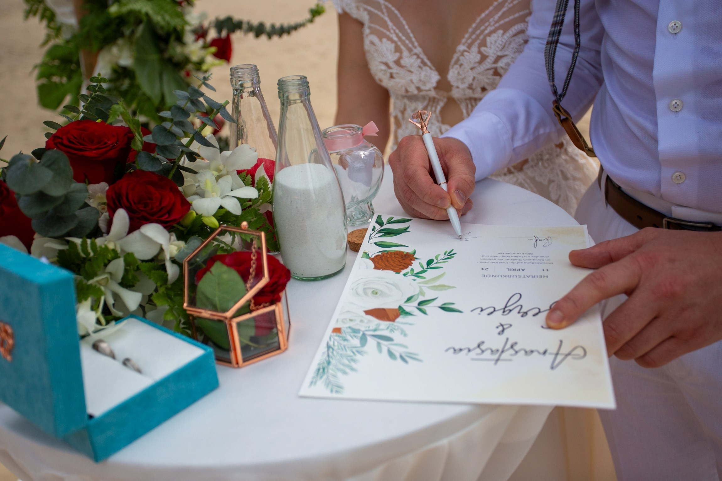 Bride and groom during a romantic beach wedding ceremony on Koh Samui, Thailand, surrounded by tropical scenery and ocean views