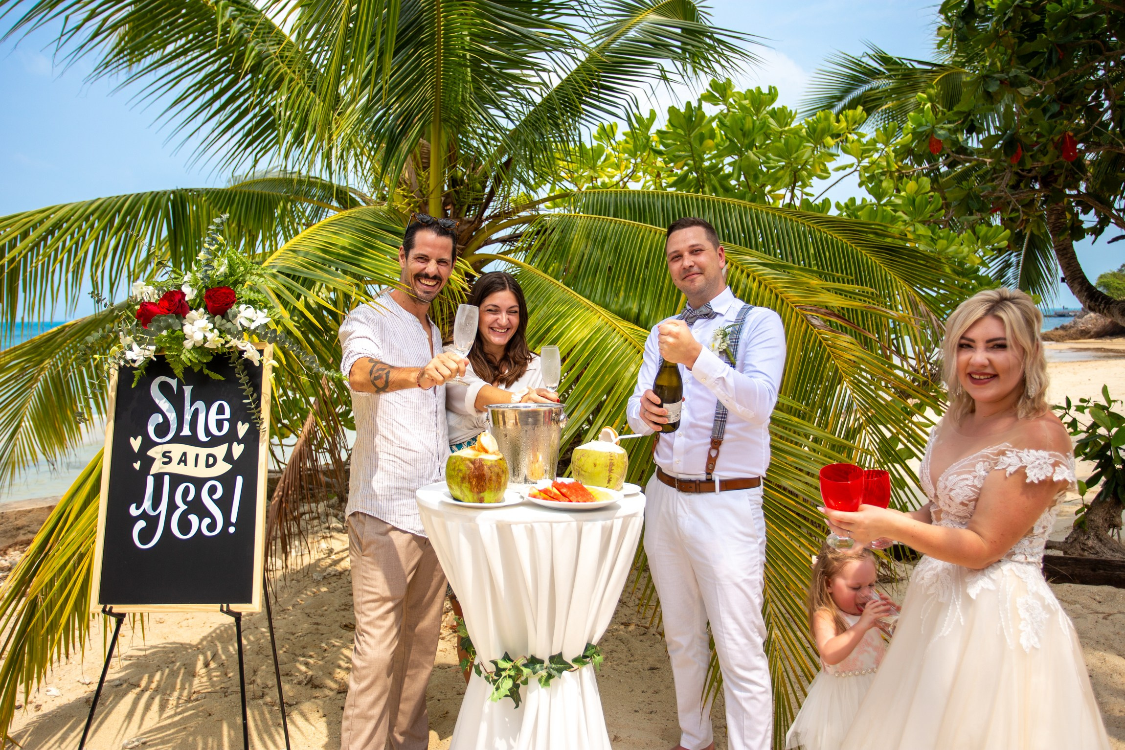 Elegant beach wedding setup on Koh Samui, Thailand with bride, groom, flowers and stunning sea backdrop