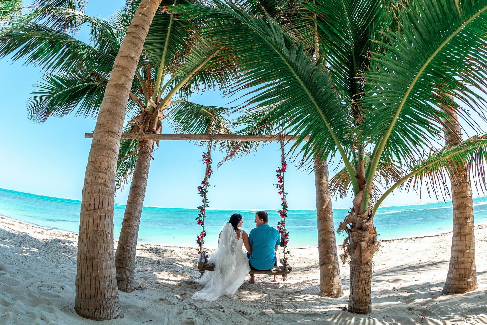 Romantic beach wedding photography in Punta Cana during a sunset ceremony.