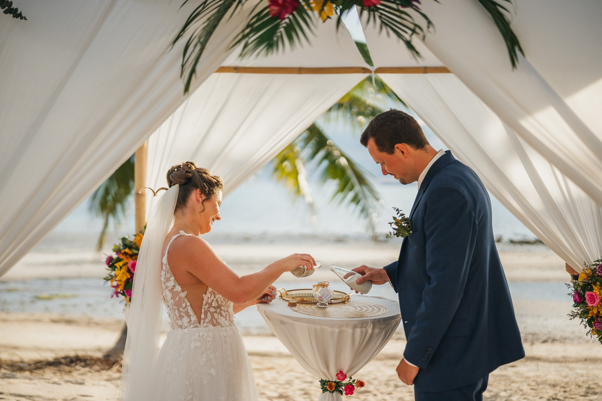 Destination beach wedding in Koh Samui, Thailand with the couple, family members and friends enjoying a tropical wedding ceremony by the sea