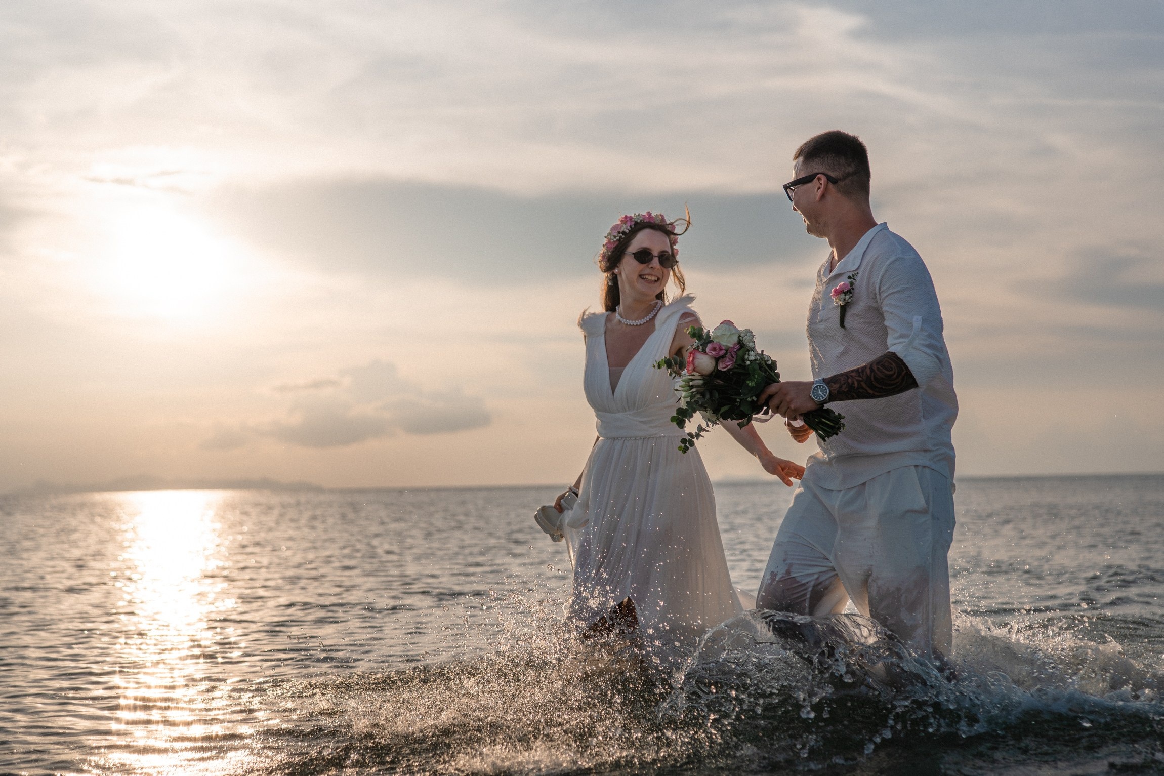 Bride and groom exchanging vows on a private sunset beach