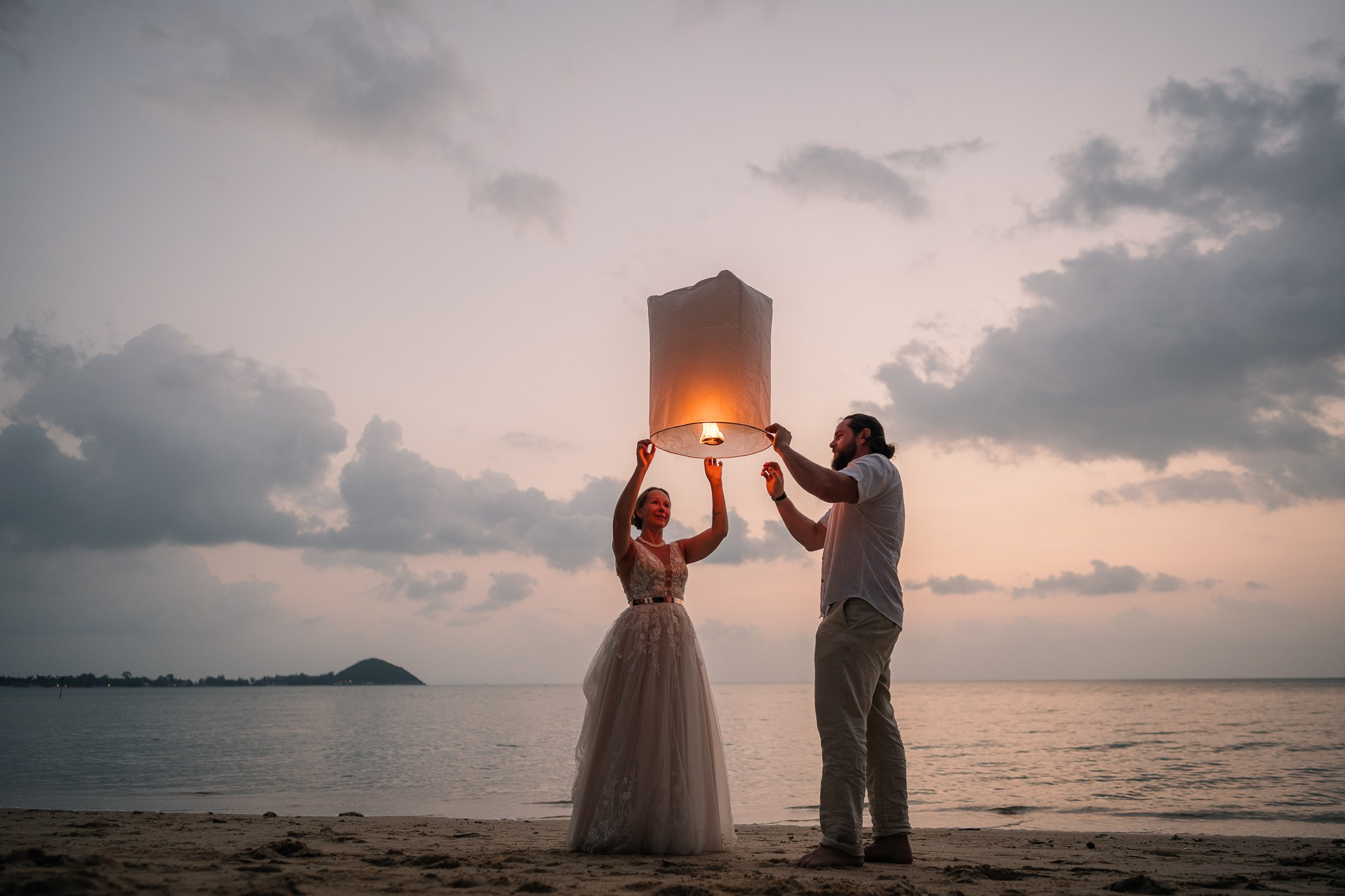 Destination beach wedding in Koh Samui, Thailand with the couple, family members and friends enjoying a tropical wedding ceremony by the sea