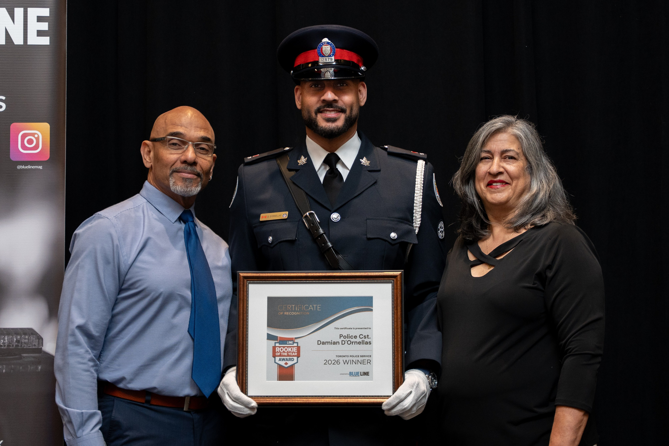Officer and colleague posing with certificate, Blueline Expo 2026