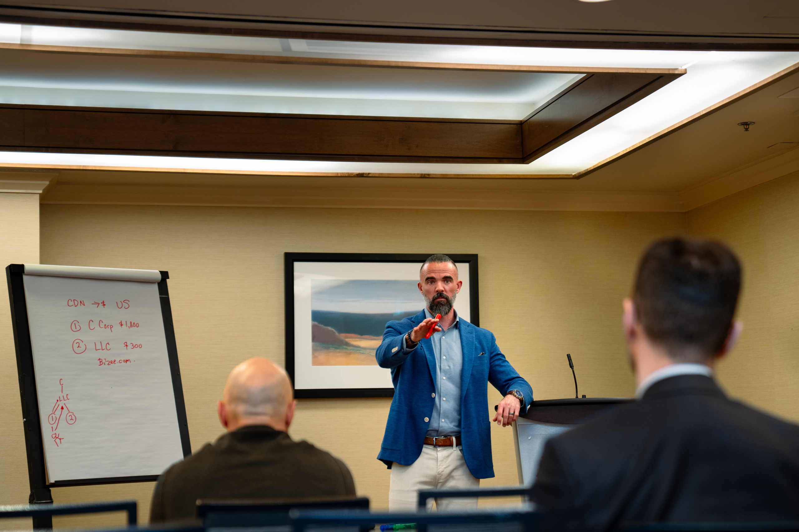 Speaker presenting to seated audience at networking event