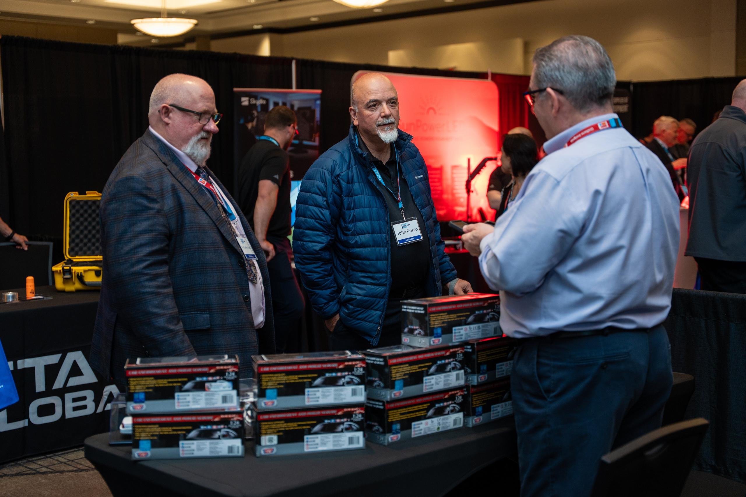 Two exhibitors taking with other person, Blueline Expo 2026