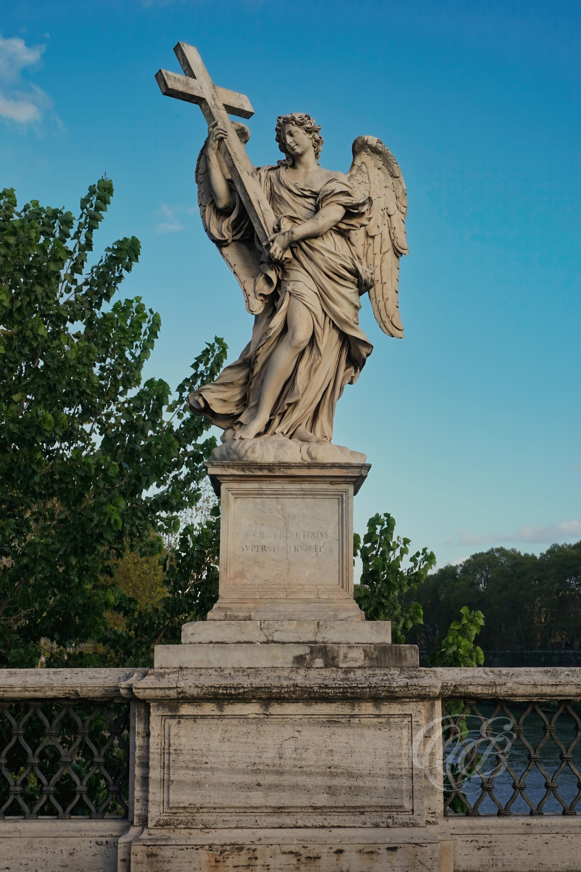 ITALY TRAVEL PHOTOGRAPHY – ITALY – ROME — Ponte Sant’Angelo Angel with the Cross — Baroque angel sculpture holding the cross on Ponte Sant’Angelo, designed under Gian Lorenzo Bernini, spanning the Tiber River in Rome, Italy — Eduardo Bartoli Photography.