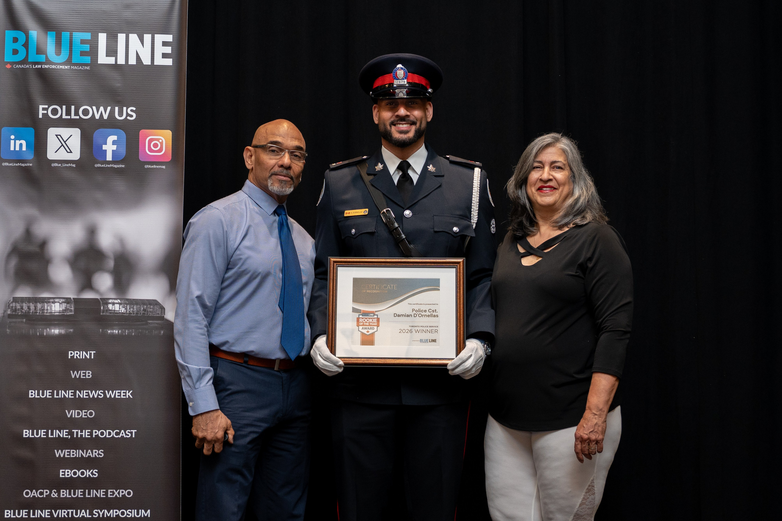 Award recipient posing with GeoWarehouse backdrop, Blueline Expo