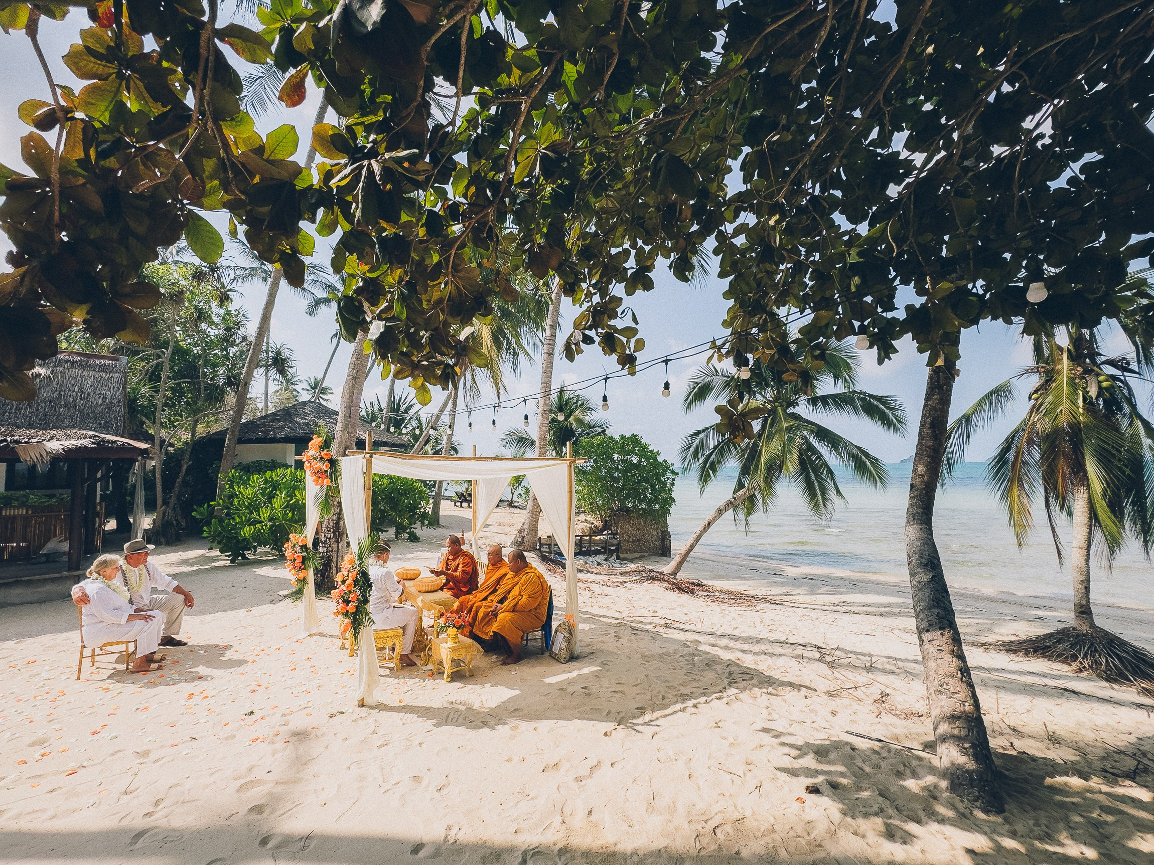 Couple celebrating a spiritual Buddhist wedding ceremony on Koh Samui