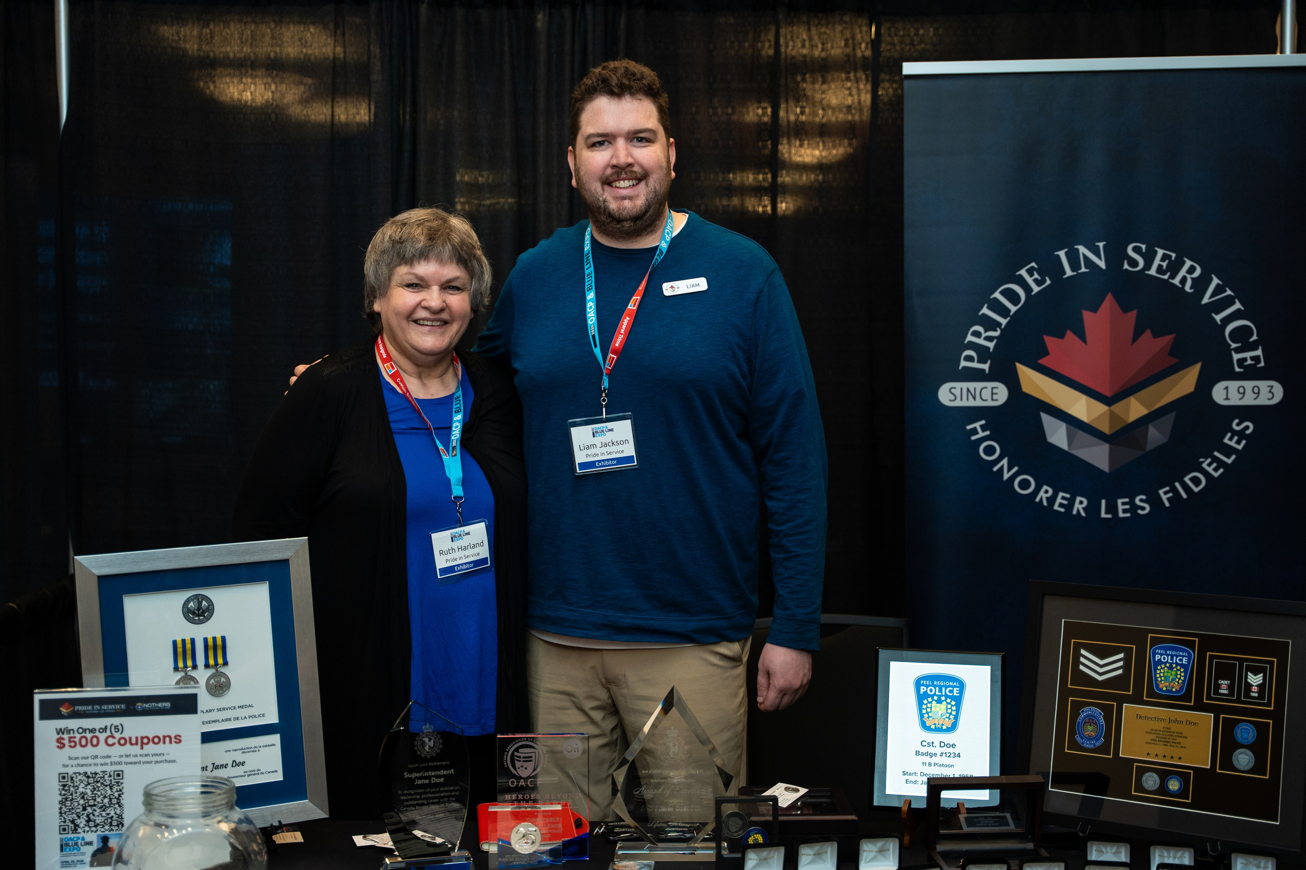 Group of exhibitors posing at booth, Blueline Expo Toronto