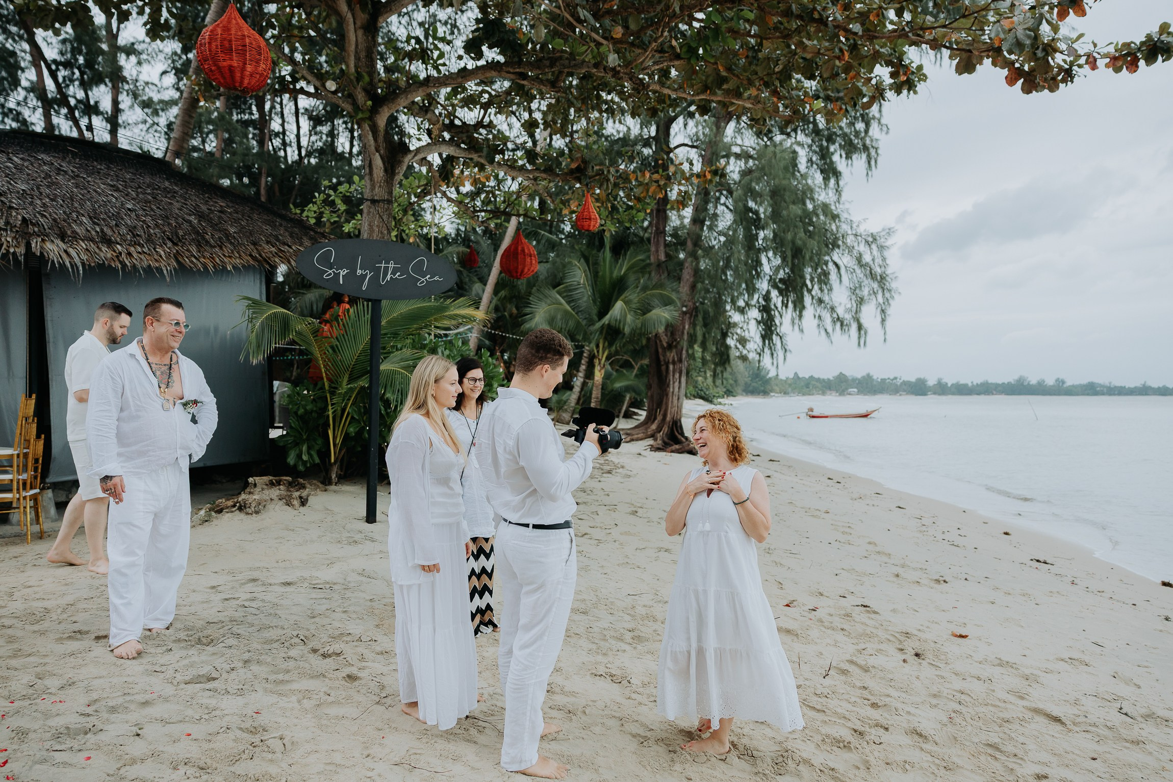 Bride and groom participating in a sacred Buddhist wedding blessing in Thailand