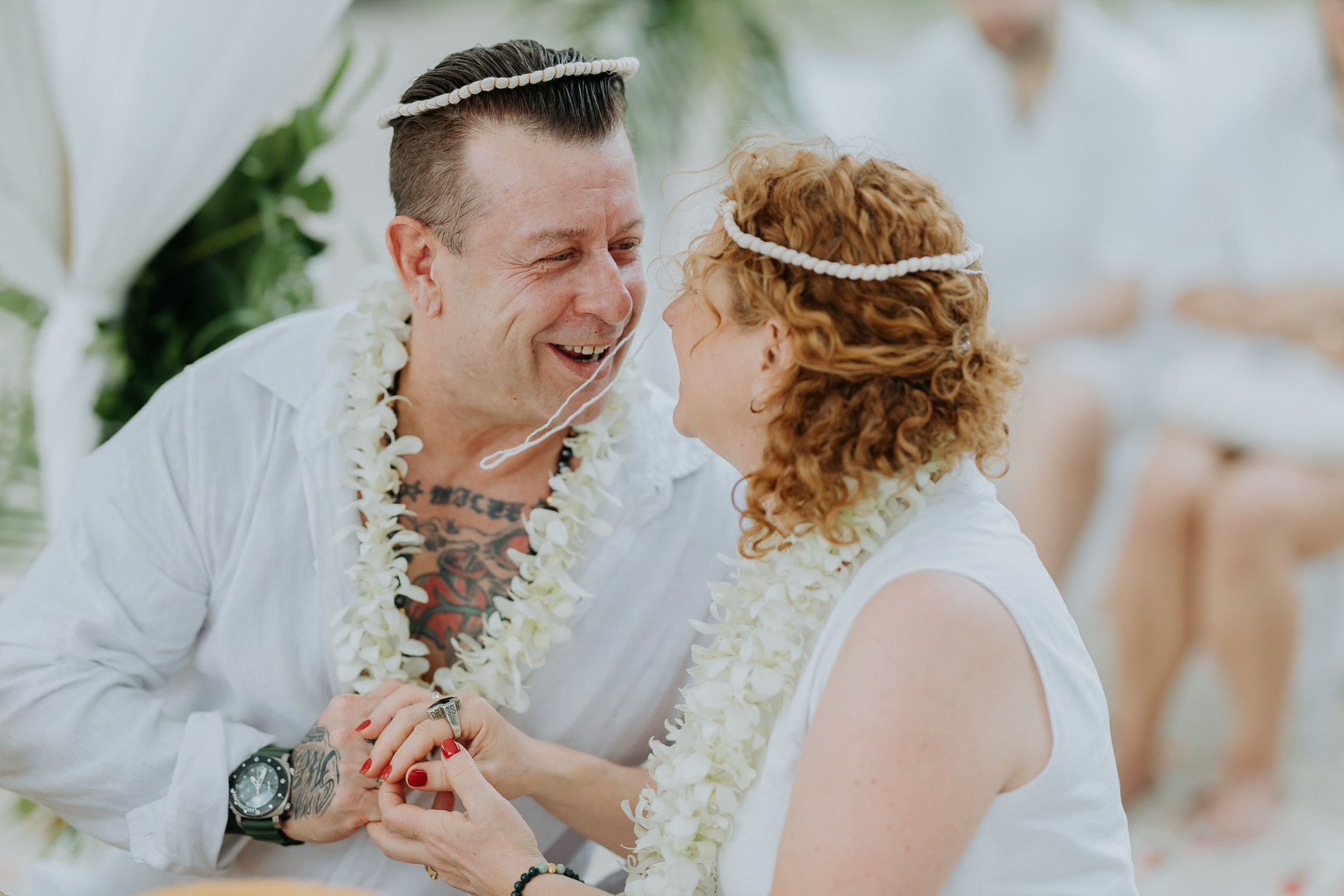 Couple with guests celebrating a spiritual Buddhist wedding ceremony on Koh Samui